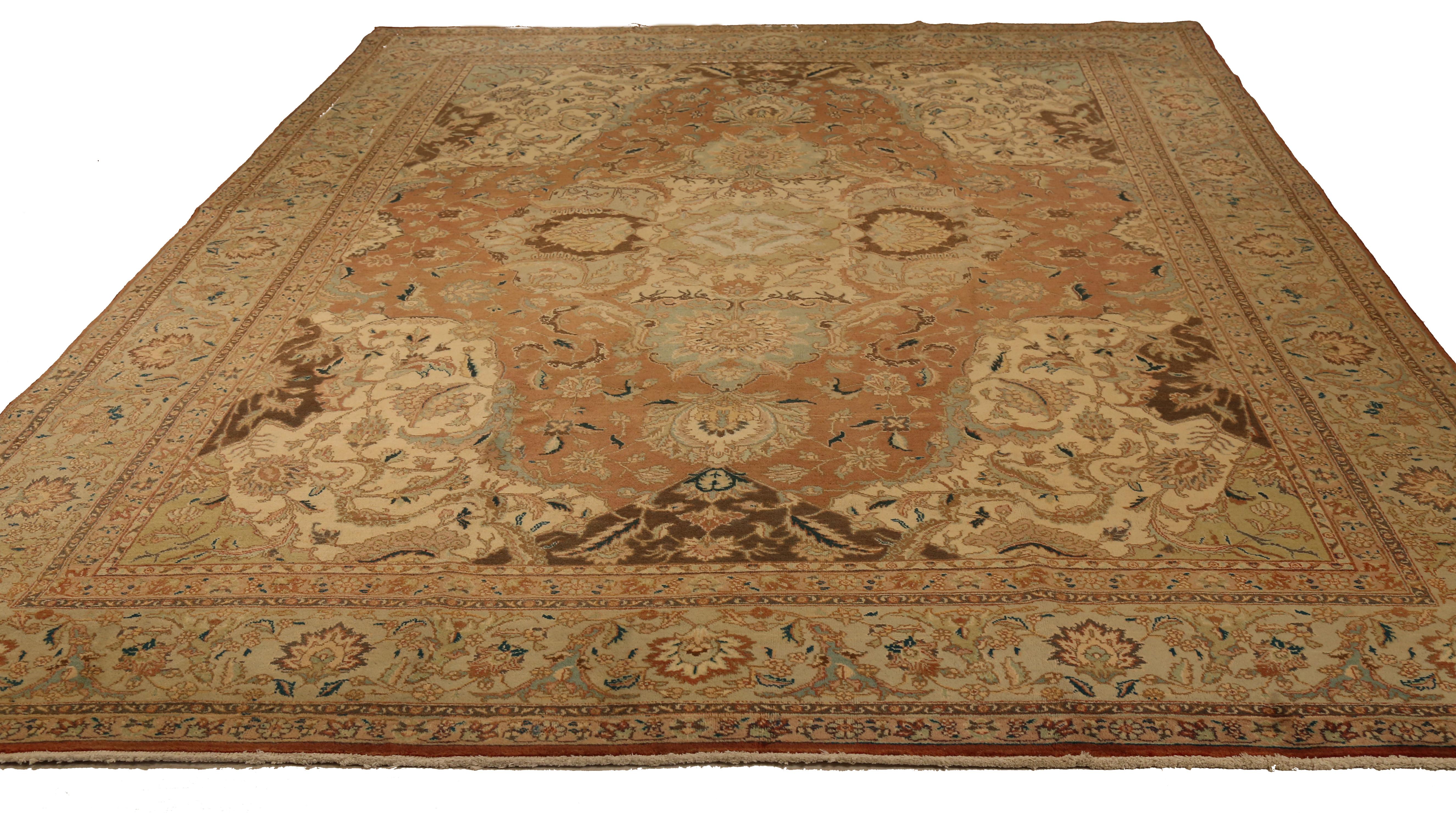Mid-20th century hand-woven Persian area rug made from fine wool and all-natural vegetable dyes that are safe for people and pets. It features traditional Tabriz weaving depicting intricate botanical and animal patterns often in bold colors.