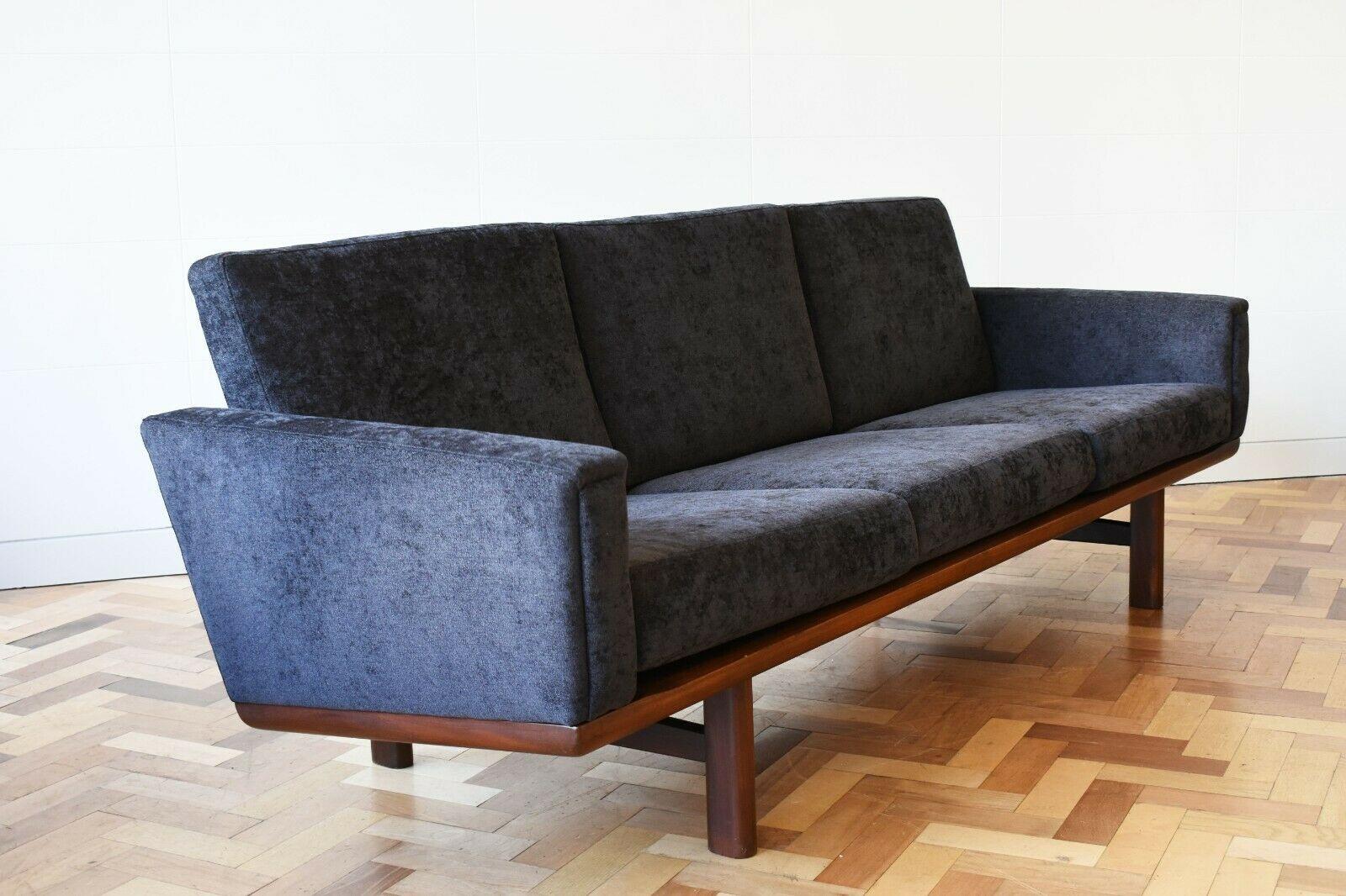 Brilliant Model GE-236/3 three seater sofa designed by Hans Wegner and manufactured by Getama. This elegant piece's teak wood base forms a lattice at the back and supports the seating. The sofa has been recently upholstered in 80,000 rub high