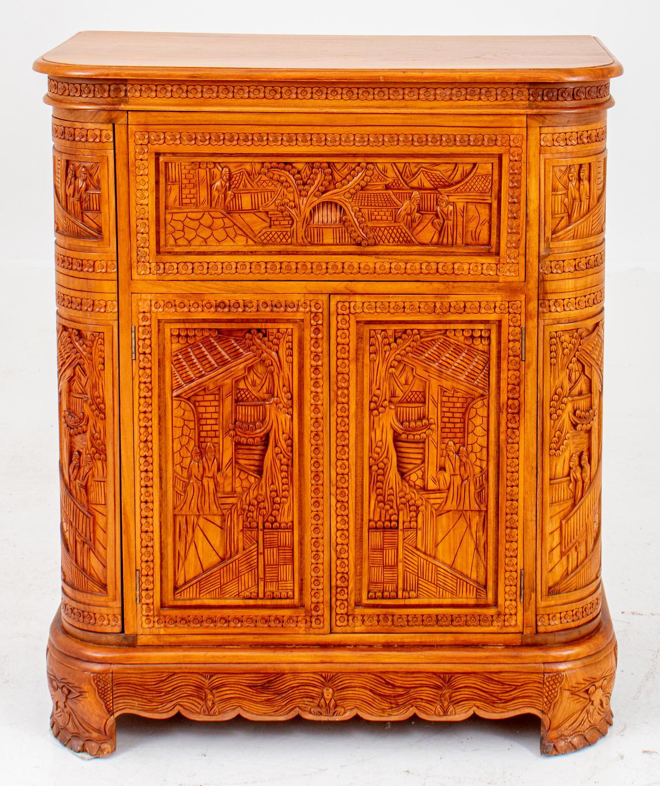 Beautiful craftsmanship and hand carved aromatic wood cocktail bar cabinet. the bar cabinet features heavily urban chinoiserie carved scenes detail with rounded rectangular top and a drop front opening to reveal a fitted bar above a two-door