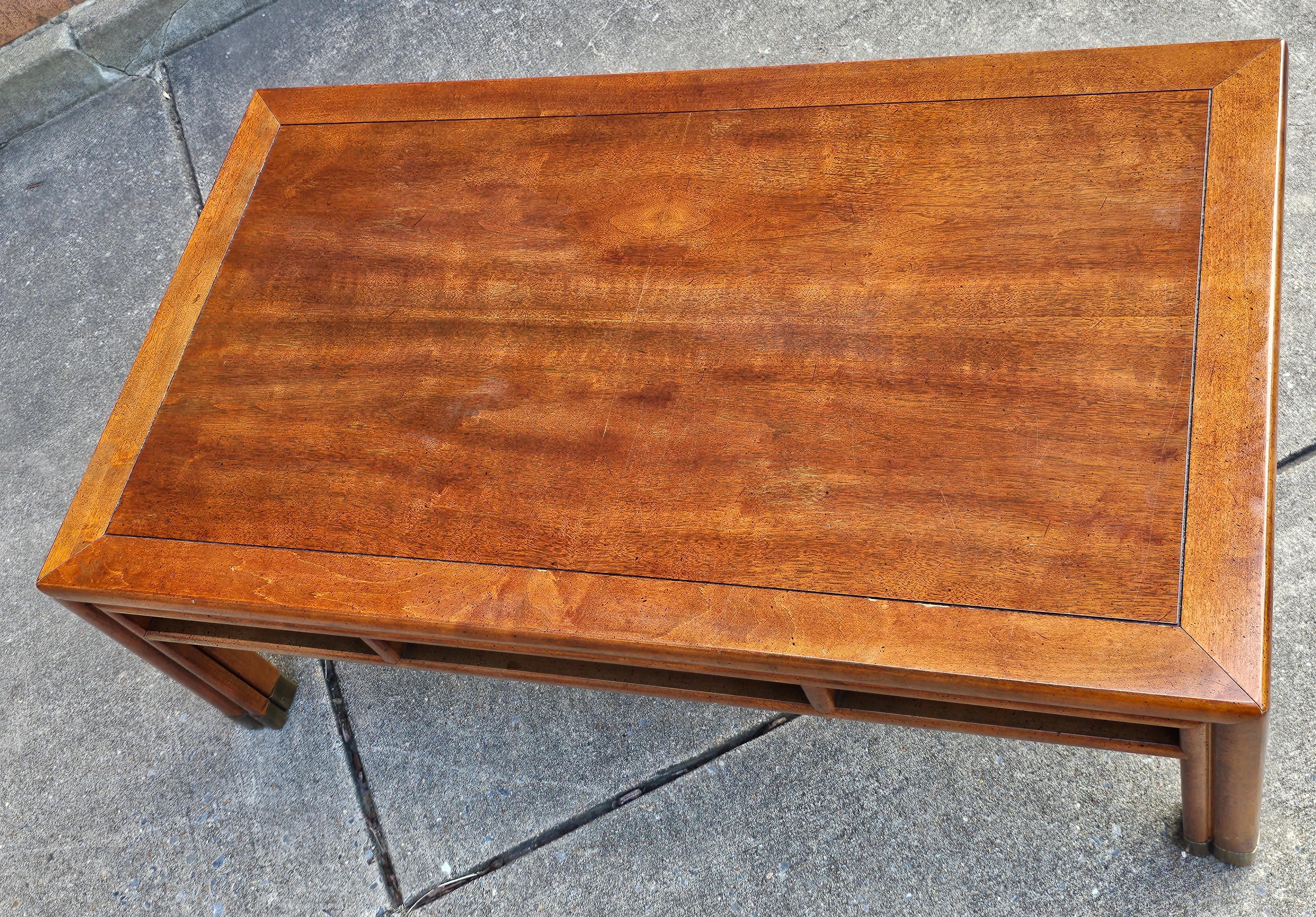 Mid-20th Century Henredon Asian Style Fruitwood and Brass Mounted Feet Coffee Table in good vintage condition. 
Measures 45