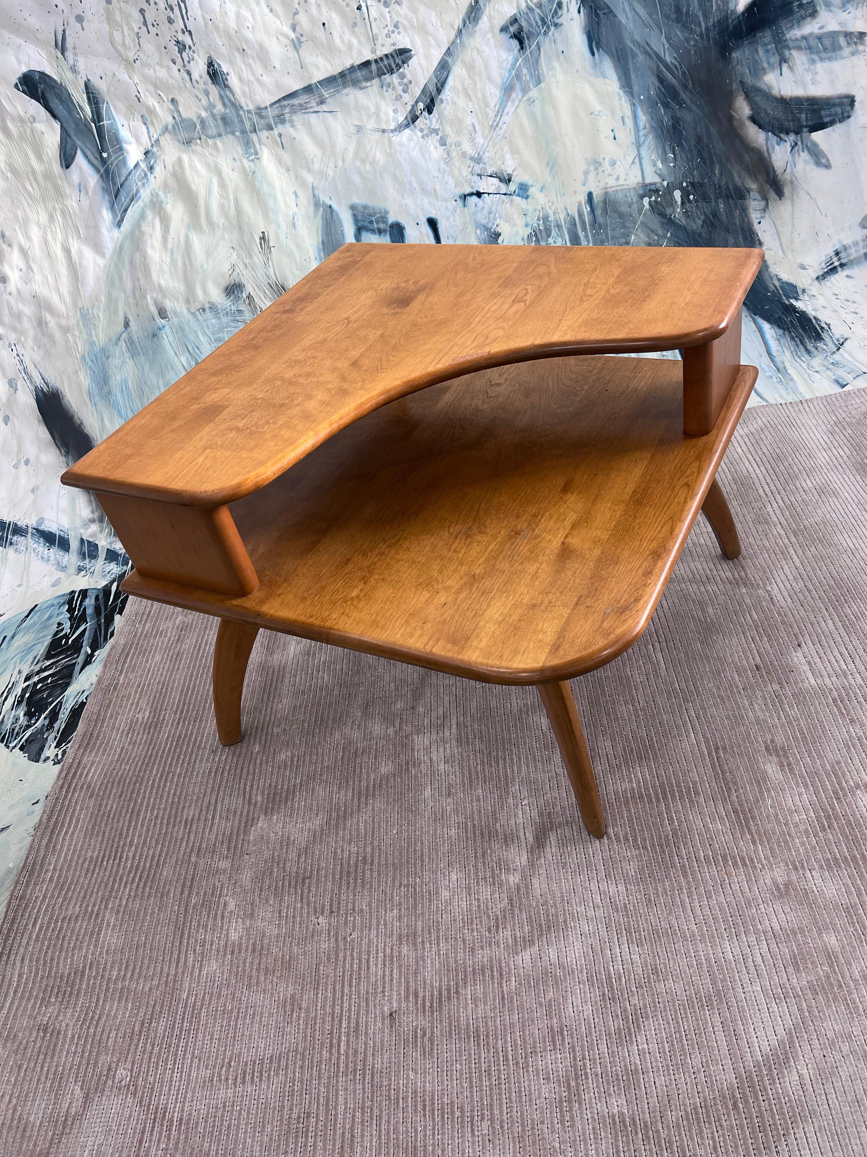 Vintage Heywood Wakefield wishbone two-step corner table constructed of solid birch with convex legs. 