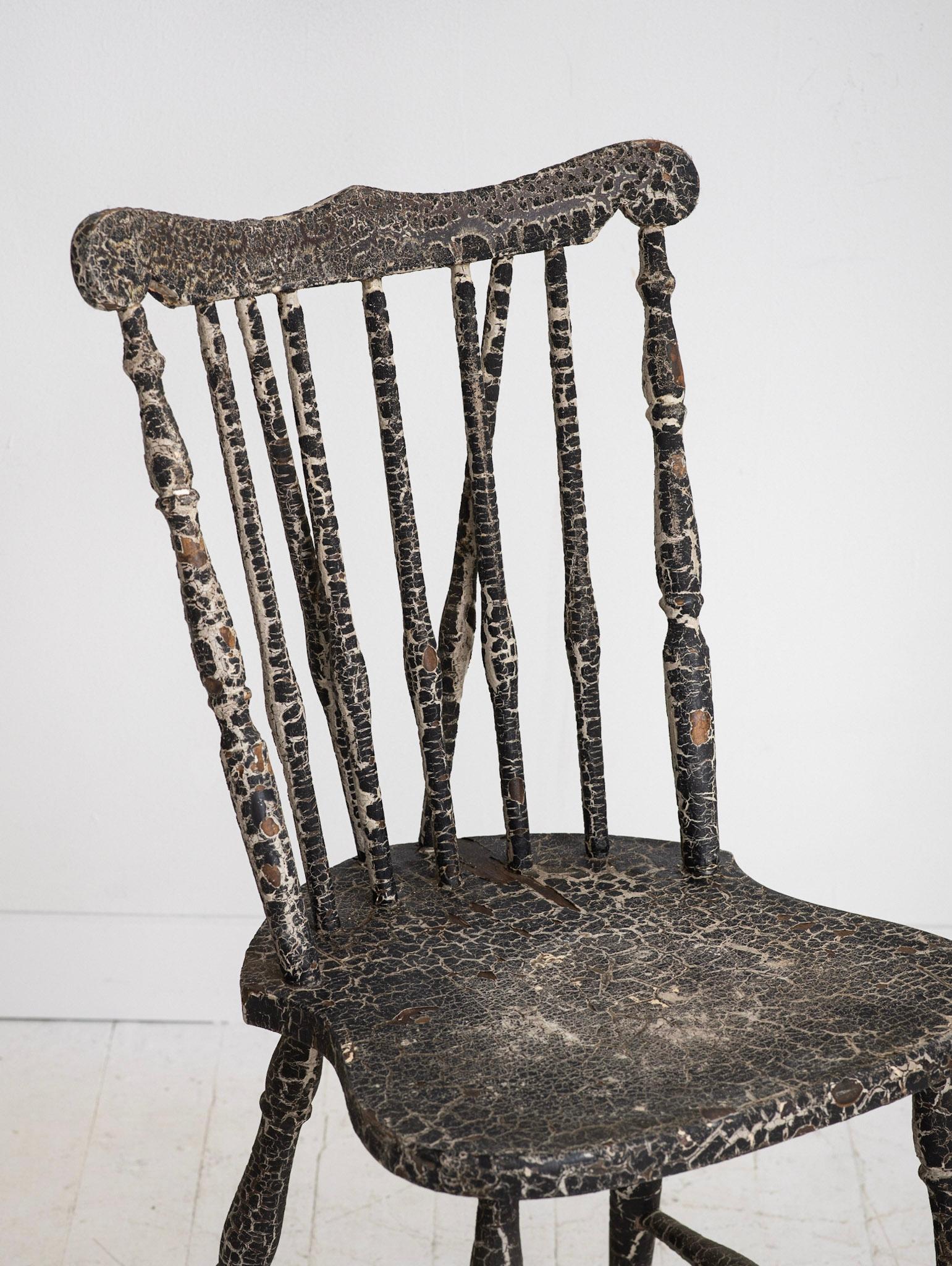Antique wood chair with a wonderful natural patina. The paint has aged over time to create a thick textured crackle finish. Chair is usable but is best suited as a decor piece.