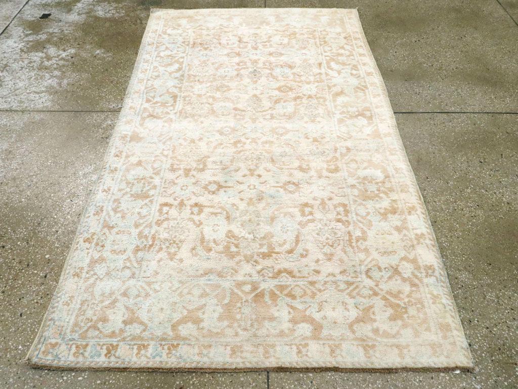 Un tappeto vintage in cotone indiano Agra. Un motivo Herati allover modificato in beige ed ecrù ricopre dolcemente il campo di ruggine di questo tappeto Townes dell'India settentrionale con vello interamente in cotone e tavolozza bitonale. Il bordo