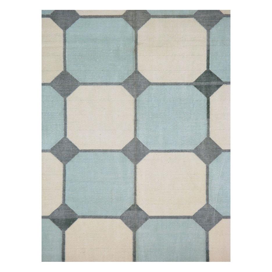 A vintage Indian flat-weave cotton dhurrie room size carpet handmade during the mid-20th century in shades of grey, blue, and cream/white. Dhurries were originally intended for summer homes as cotton is cooler on the feet than wool. To this day,