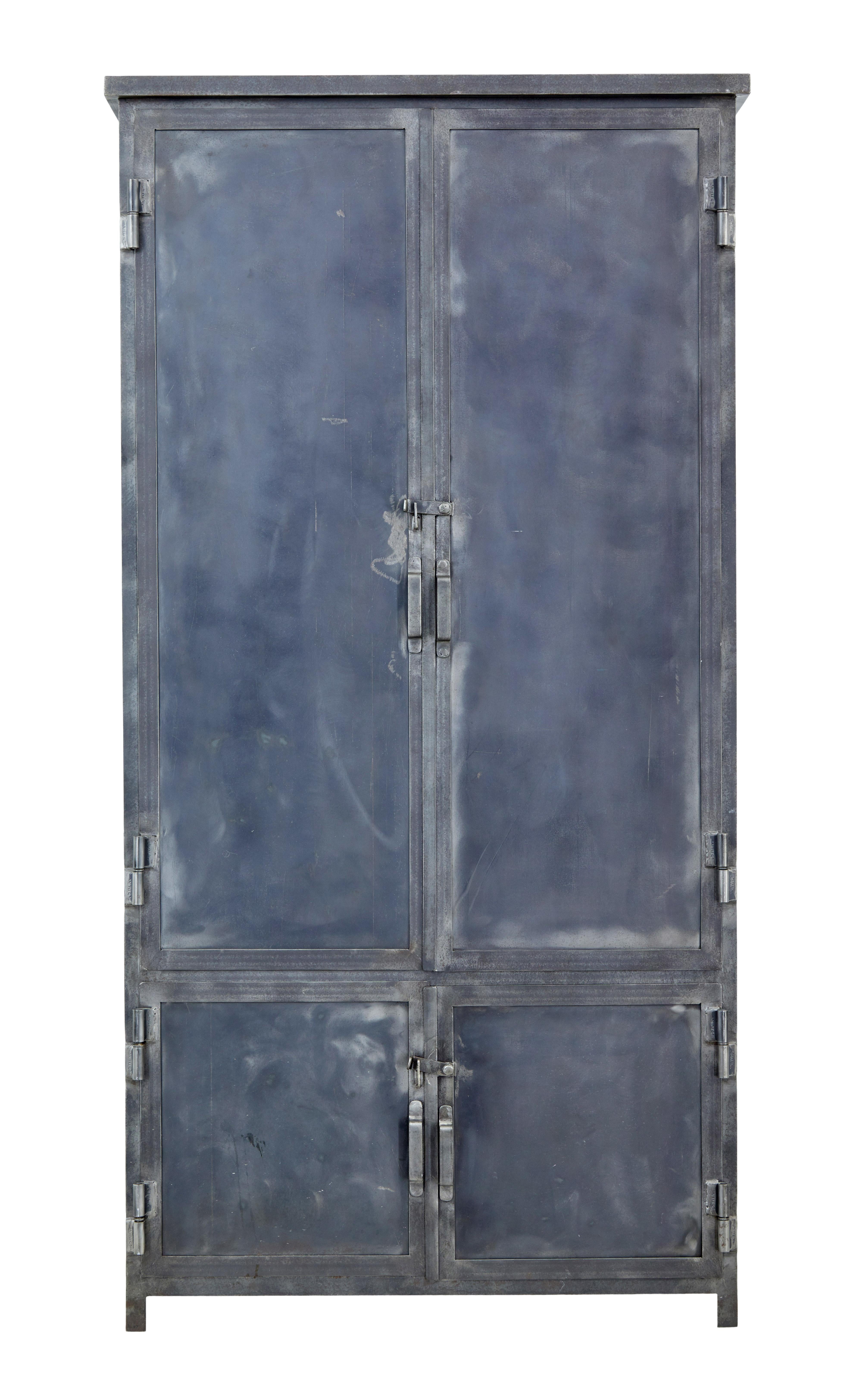 Good quality handmade industrial inspired steel cabinet, circa 1960.

Comprising of a double door cabinet with 2 fixed shelves to the top and a double door smaller cupboard below. Each door fitted with latches and handles. All doors fitted with