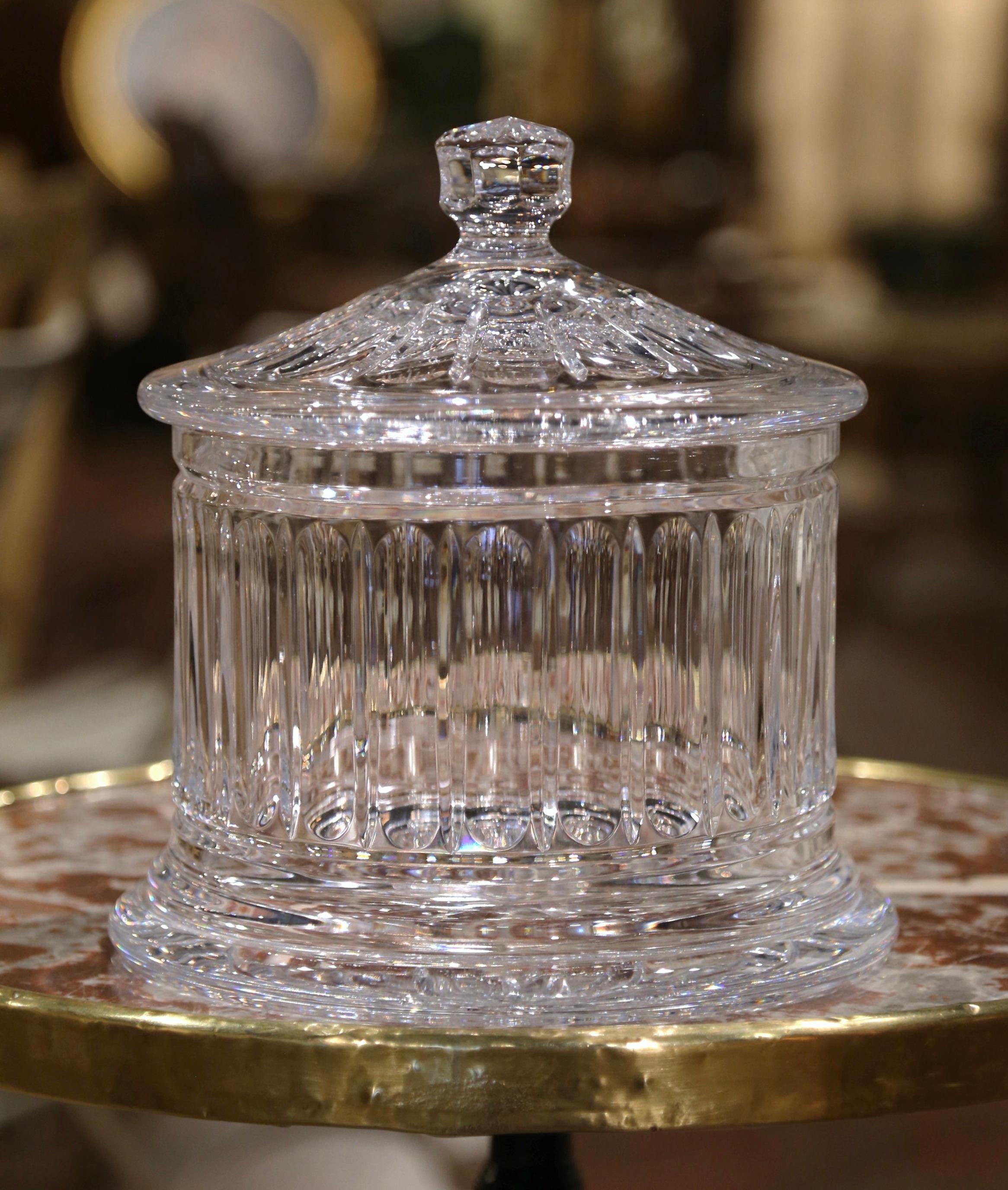 Bring a touch of historic glamour to a console, kitchen or office space with this important vintage crystal cookie jar. Created in Ireland circa 1960 and round in shape, the clear container features etched geometric decor. The large glass jar has a