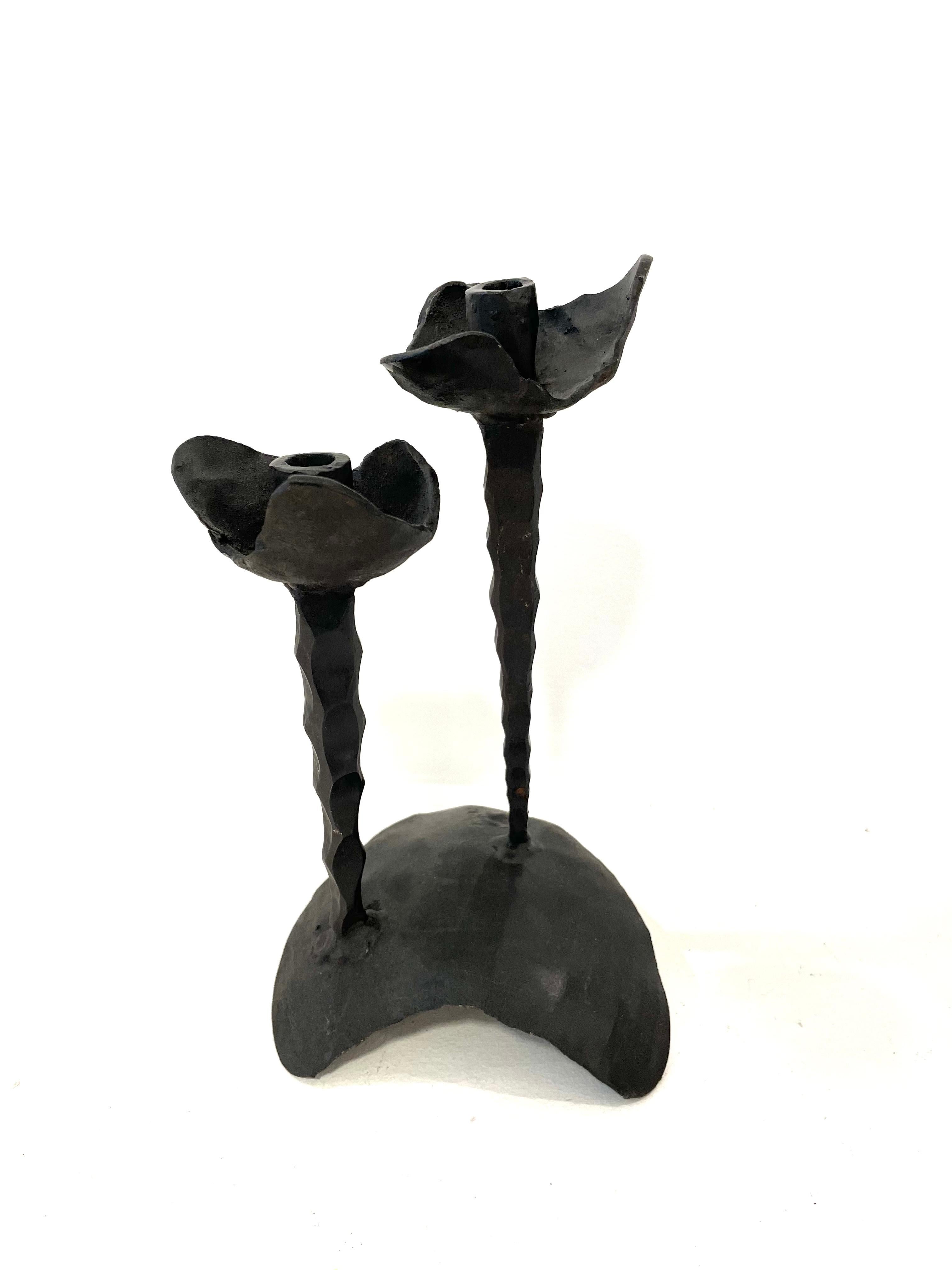 Iron Shabbat candle holder crafted in brutalist style by David Palombo. Made for two candles, each of the holders is decorated with petals-like shapes, providing an overall floral motive to this candle holder. 

David Palombo (1920-1966) was a