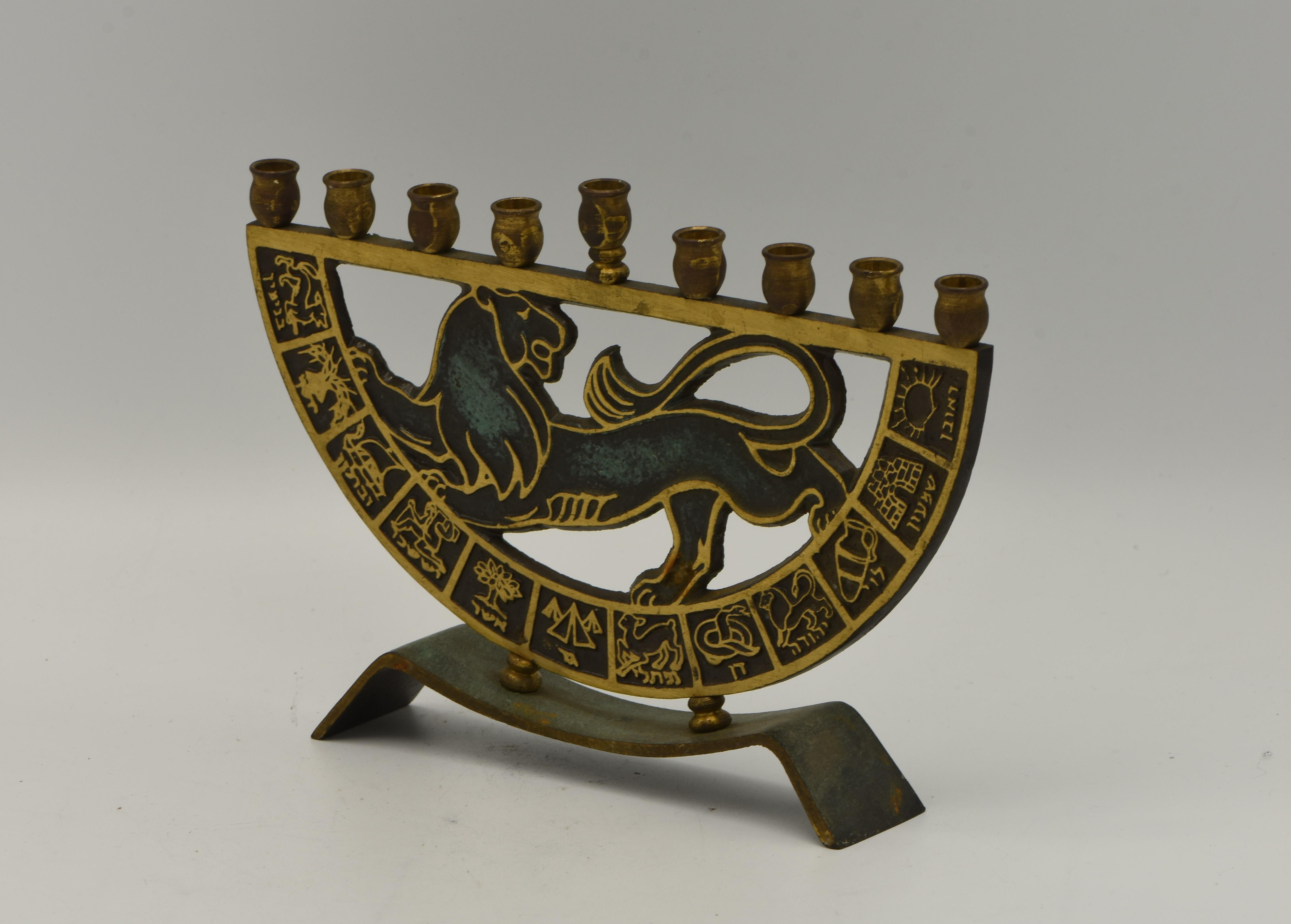 Hanukkah Lamp Menorah, brass, Israel, circa 1950.
On a rectangular base, lion of Judah surrounded by the Tribes of Israel symbols decorated with green patina. Stamped and numbered on the back.

Every item in Menorah Galleries is accompanied by a