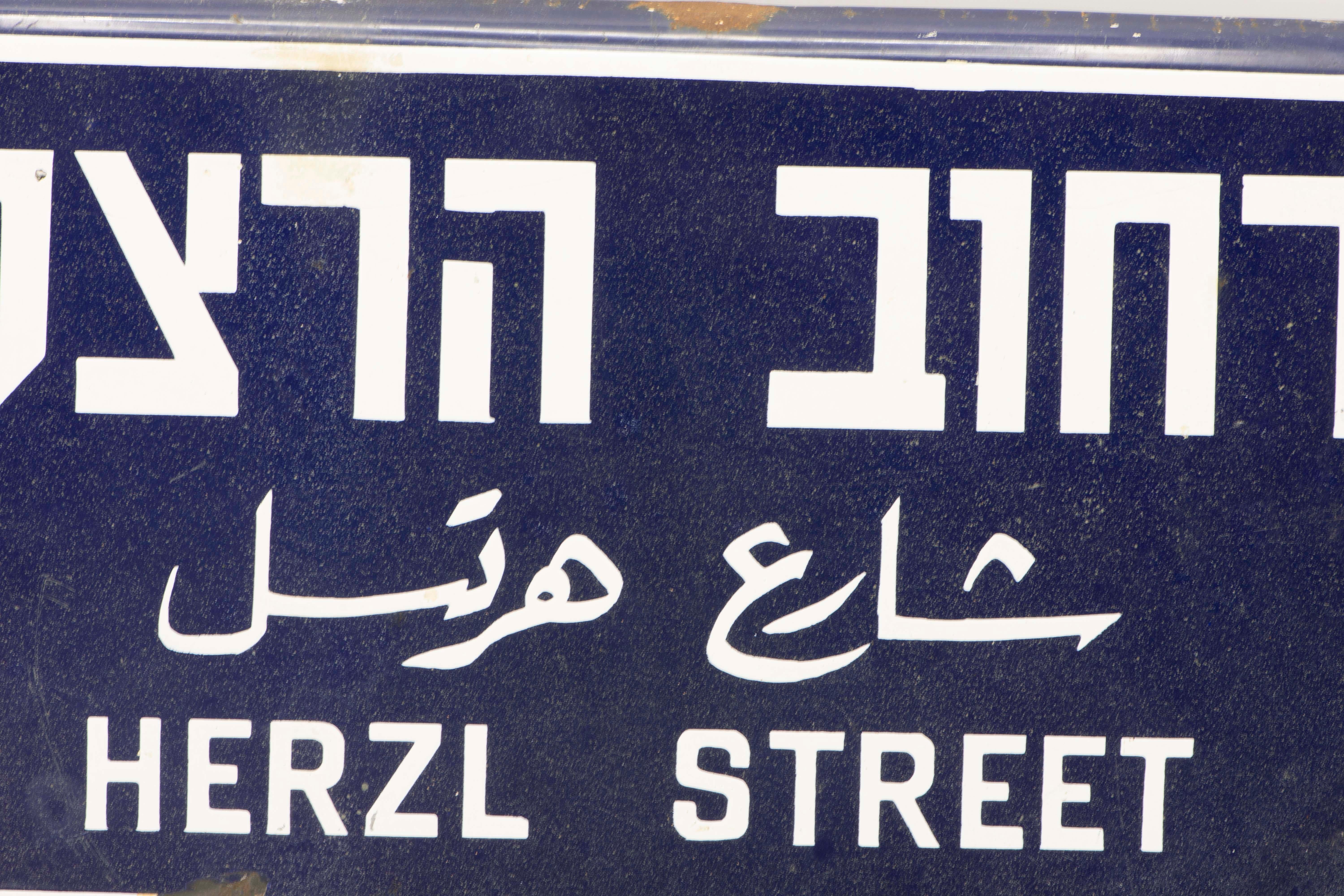 Three languages iron and enamel street sign, circa 1920.
The sign was made to Honor Theodor Herzl who was an Austro-Hungarian Jewish journalist, playwright, political activist, and writer who was the father of modern political Zionism. Herzl formed