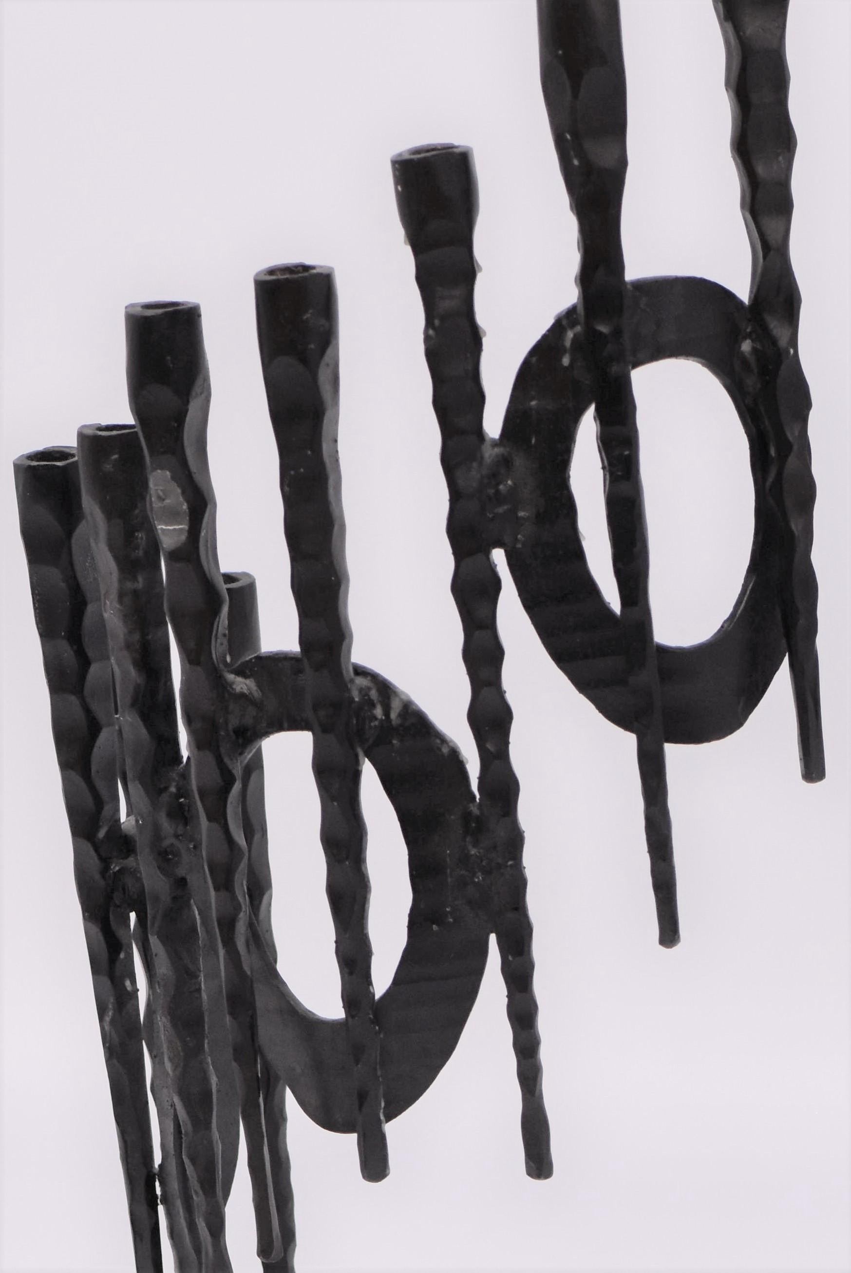 Rare, and large, hand forged, iron Hanukkah lamp Menorah in the style known as “Brutalism”, David Palombo, Jerusalem, Israel, circa 1960. 

David Palombo (1920-1966), was a sculptor and painter. He was born in Turkey and immigrated to Israel with