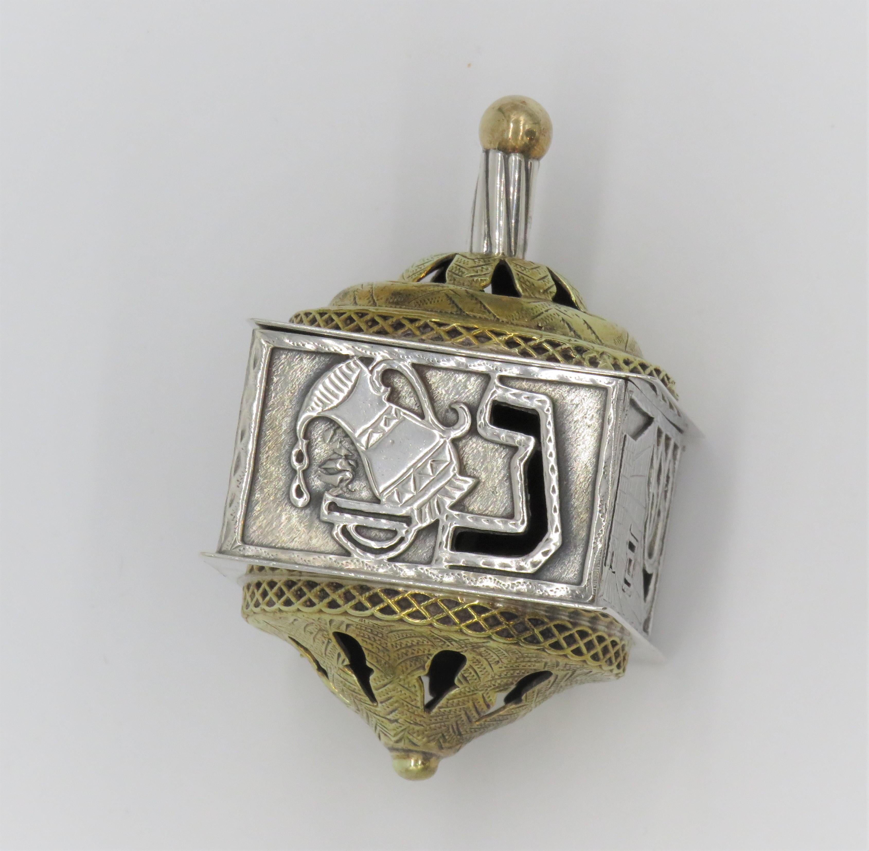 Vintage sterling silver dreidel, Israel. 
Features open work design with four Hebrew letters, and decorated with gilding.
Stamped: 