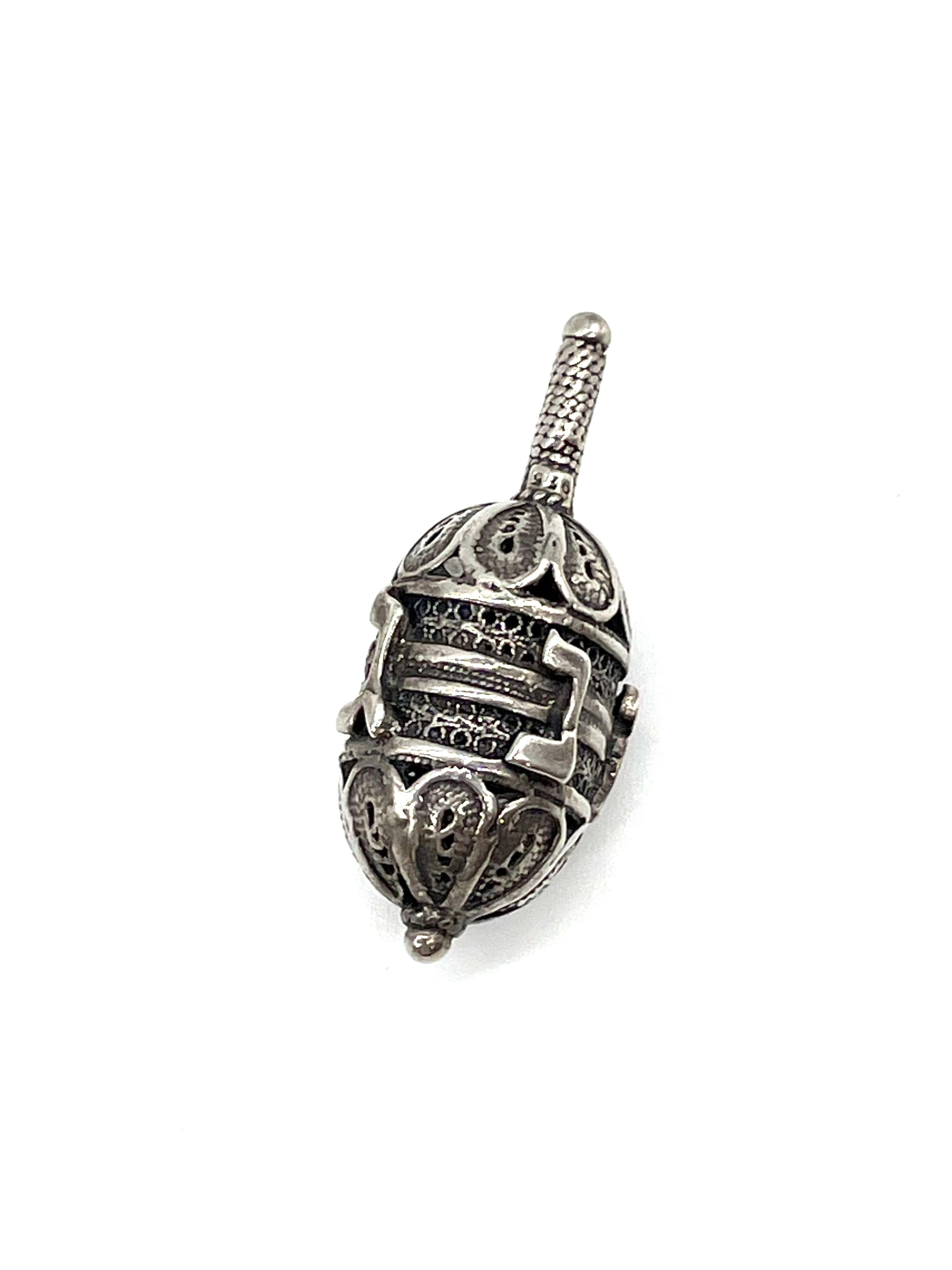 Handmade sterling silver dreidel, Jerusalem, Israel, circa 1950. 
Made from silver filigree. Stamped with Israeli silver hallmarks. The four letters nun, heh, gimel, shin are stamped in Hebrew to represent 