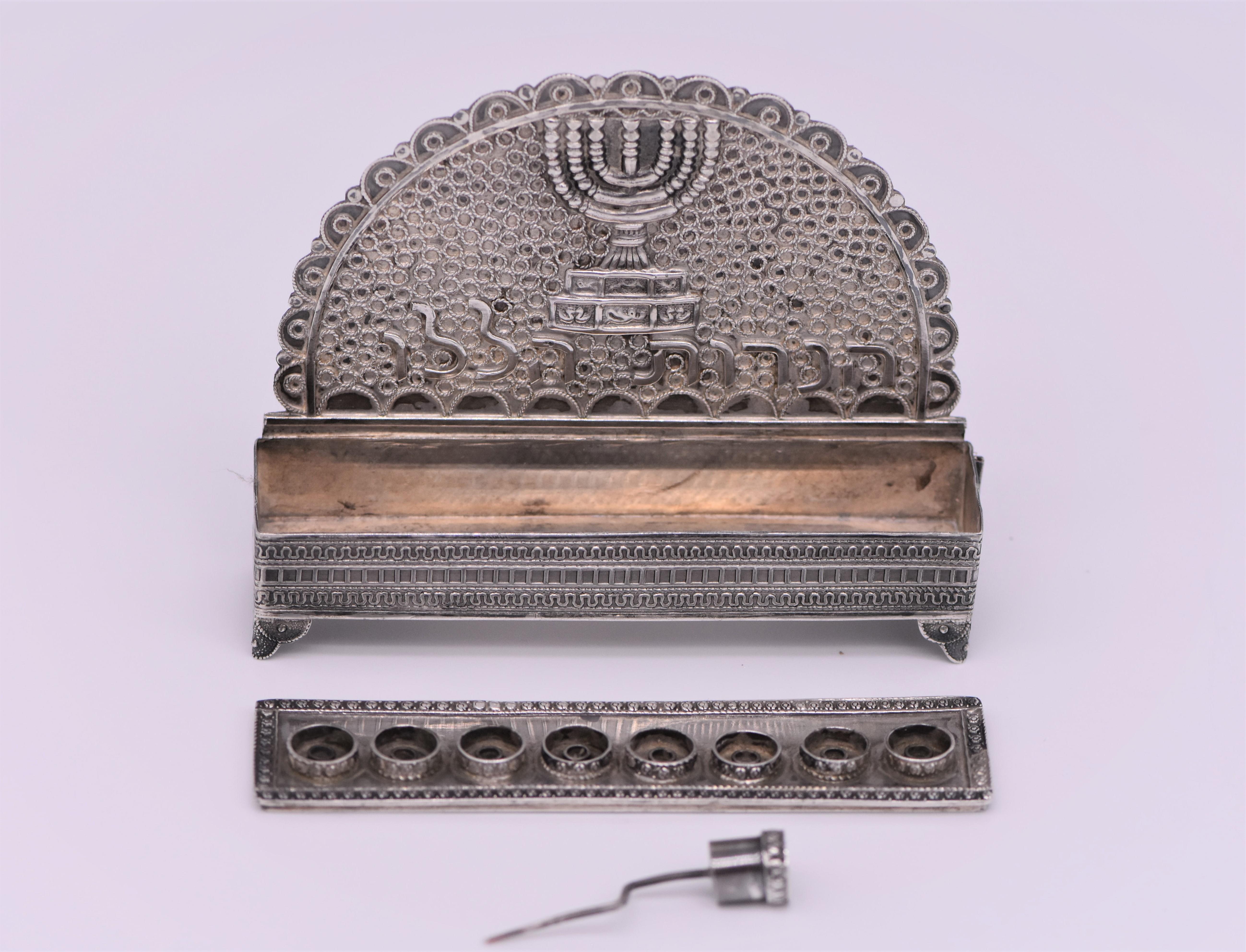Handmade silver and silver filigree Hanukkah lamp by Nir-Chen, Israel, circa 1950.
The backplate decorated with silver filigree, and applied with the Temple Menorah in the center, and with the Hebrew words: 