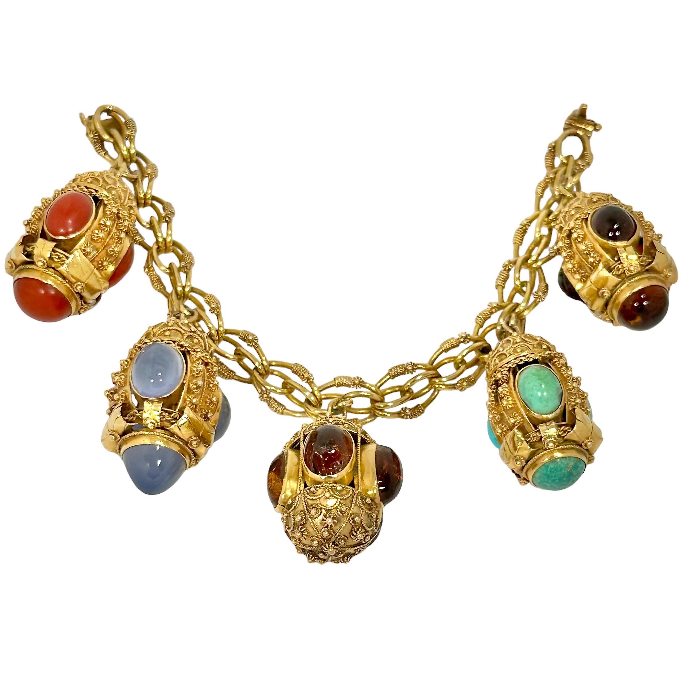 This fanciful vintage creation is uniquely the product of master goldsmiths working in Italy during the Mid-20th Century. Mounted on the very intricate bracelet of the same period are five very detailed and handmade Etruscan Revival charms, each set