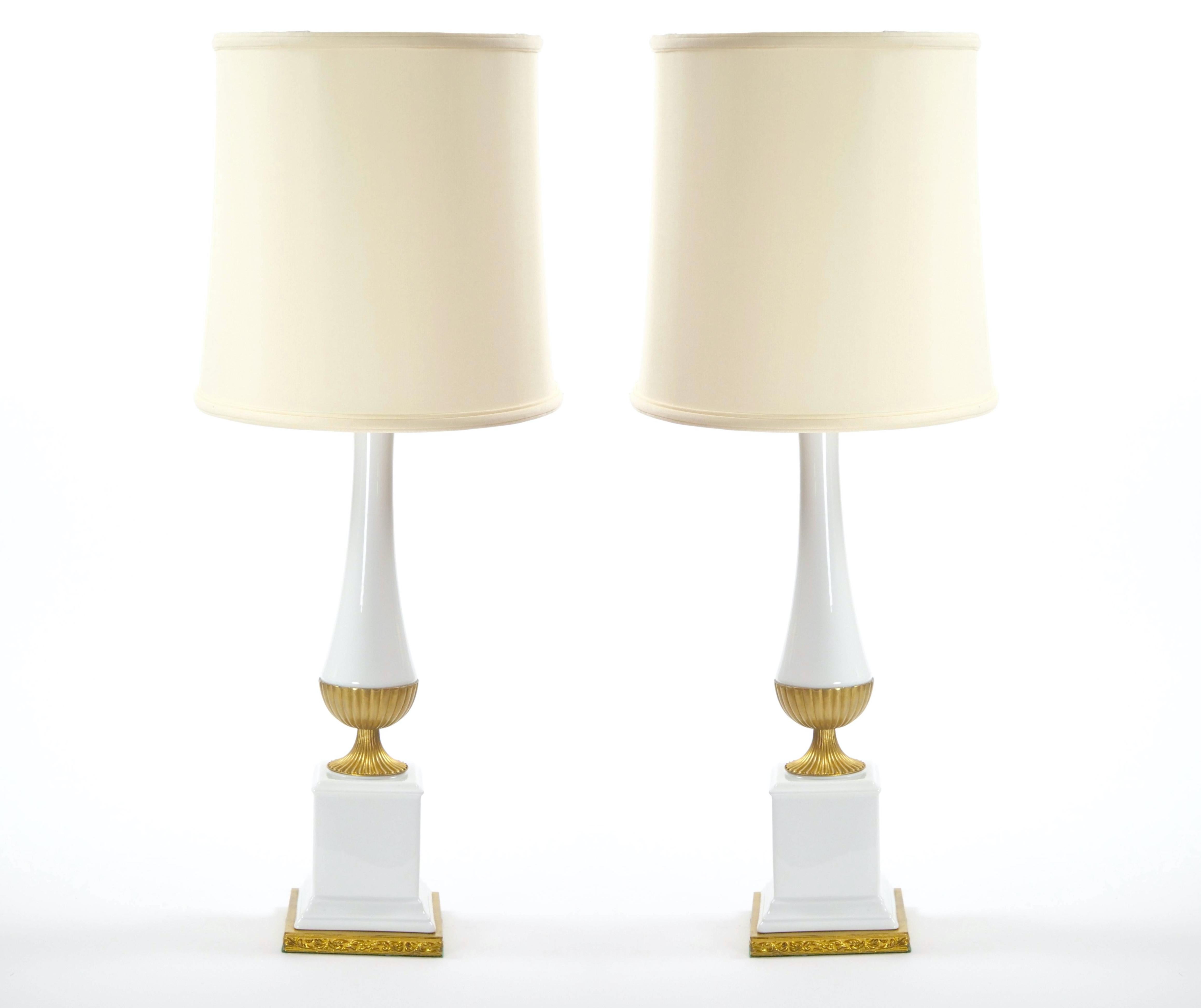 These exceptional mid-20th century Italian table lamps are a captivating blend of architectural elegance and Art Deco refinement. Each lamp features a sleek, pole-shaped glass body adorned with intricate gilt brass accents that highlight its