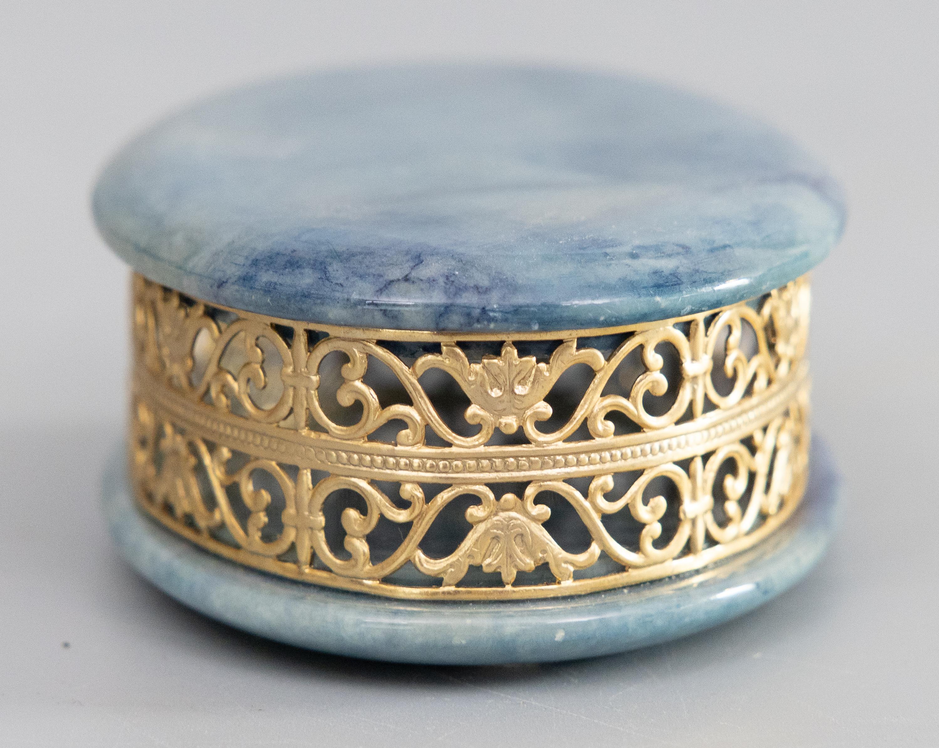 This beautiful vintage mid-century oval trinket box showcases the elegance of Italian craftsmanship, fashioned from rich blue alabaster and lovely gilt ormolu. Ideal for storing jewelry, keepsakes, or small treasures. Labeled 