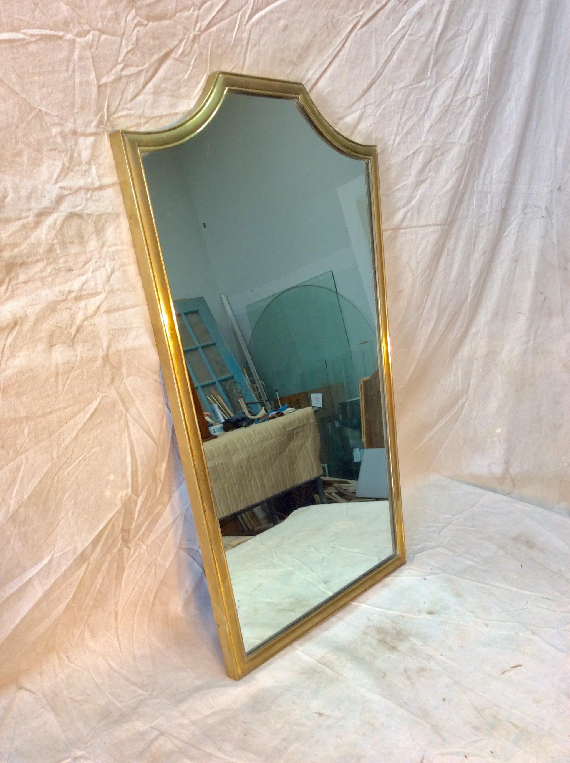 Found in Italy this Mid 20th Century Italian Brass Mirror features a rectangular shield shape with an aged brass surround. This simple and elegant vintage mirror has a lovely patina and is ready to hang.

20.5