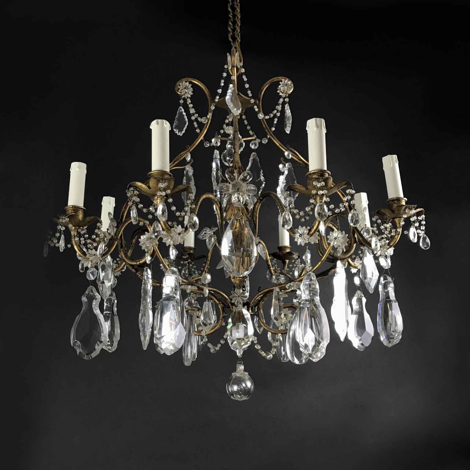 An original eight-light crystal chandelier, circular gilt iron structure, in good condition, with working wiring. Of Italian origin, it comes from a Milanese private palazzo and dates back to mid-20th century.

The cage gilt iron structure is