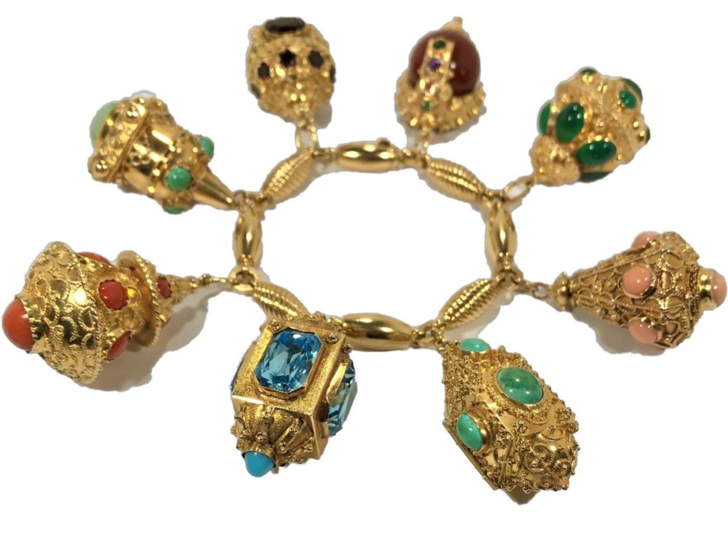This lovely 18K Yellow Gold bracelet, itself created in Verona, has mounted to it eight wonderful and large Etruscan Revival charms measuring from 1 1/4 inches to 1 1/2 inches, replete with a tremendous amount of hand crafting and wonderful detail.