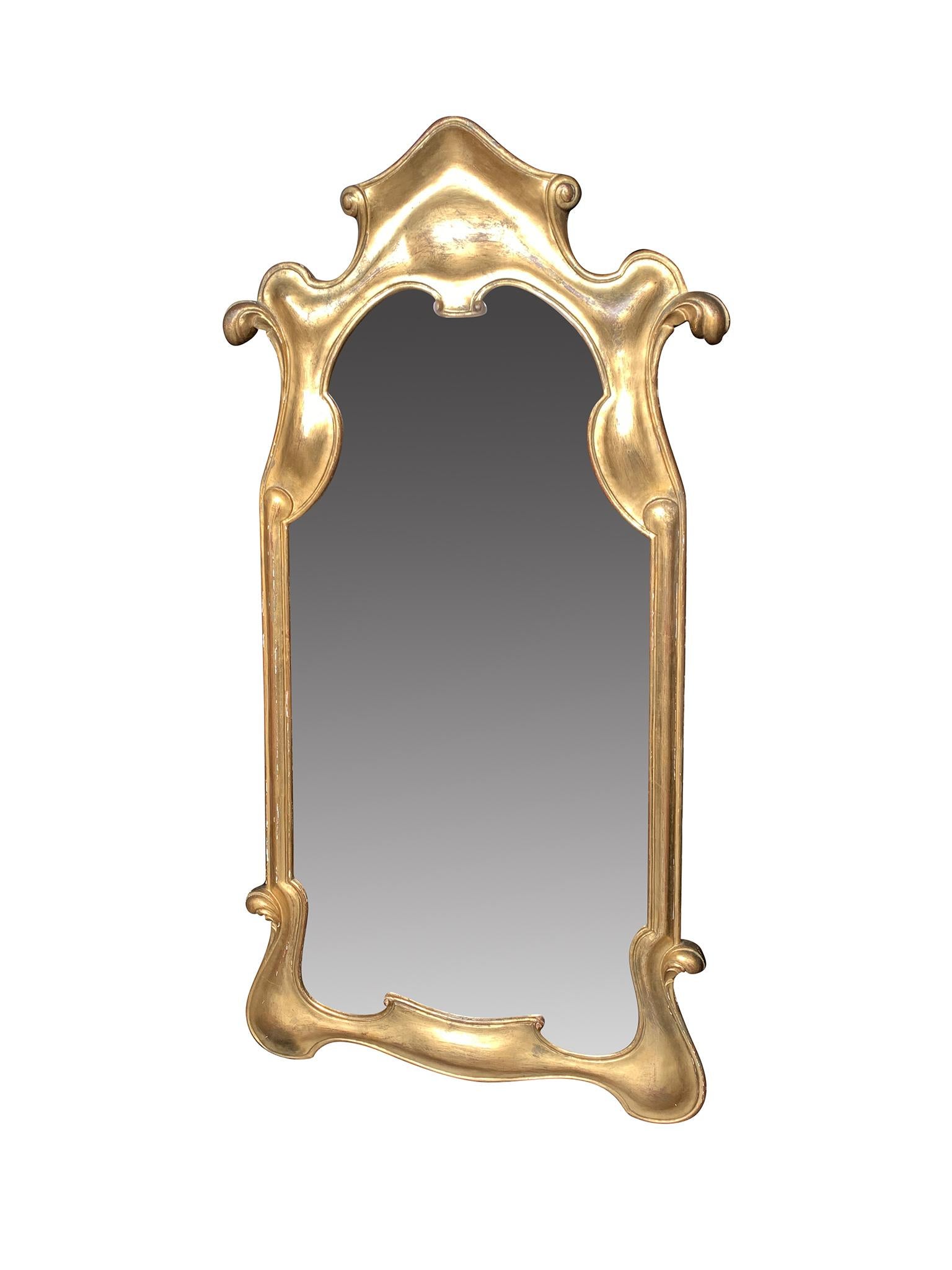 Mid-century giltwood wall mirror, crafted in Italy. The frame has beautiful smooth, rounded curves and the wood has aged well.

Dimensions:
26.25 in. width
54 in. height
1.5 in. depth

Condition notes:
In good condition with surface wear