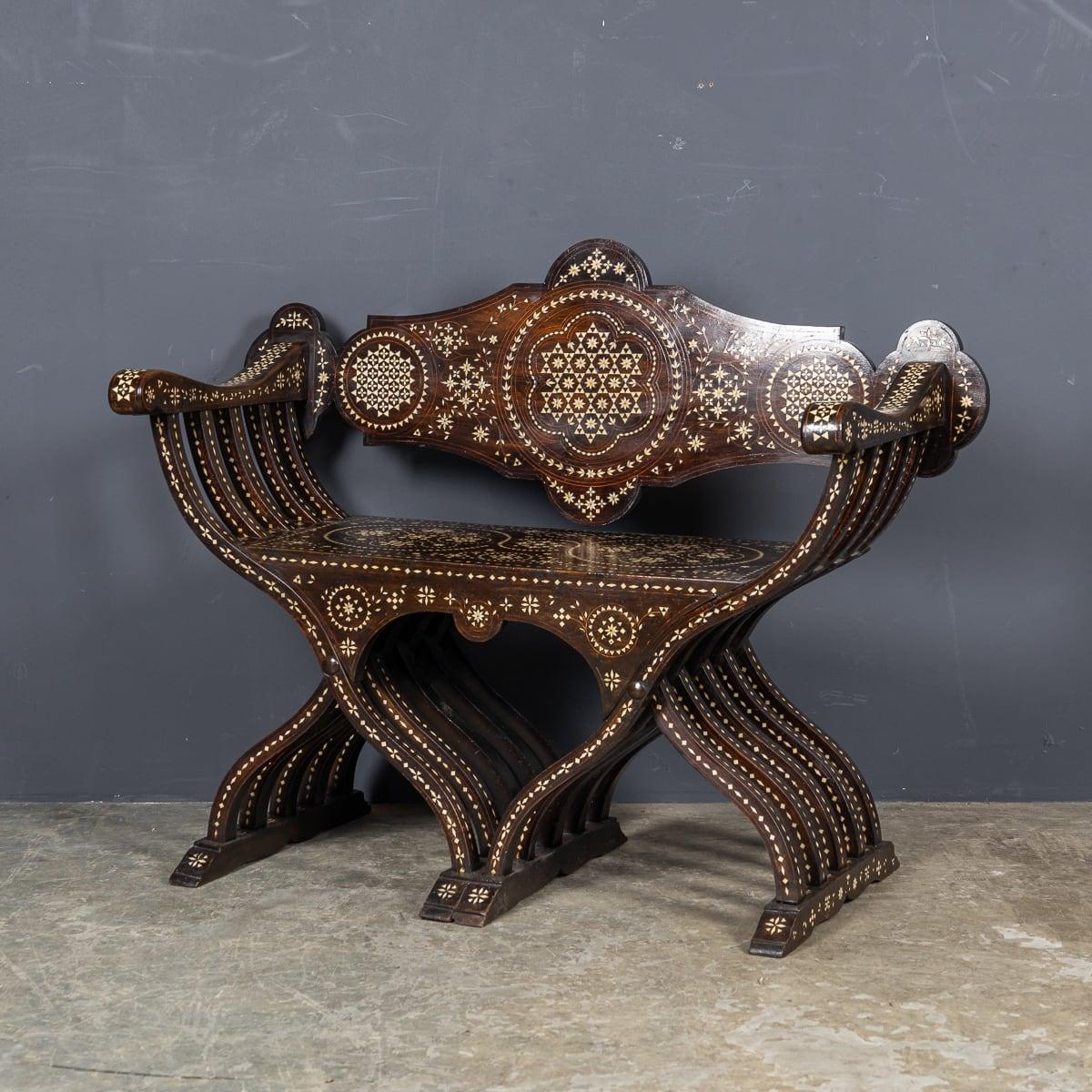 A mid 20th Century Italian chair, known as a Savonarola chair, named after a 14th-century monk. This design mimics the curule chair, a folding seat used by emissaries and rulers of the Roman Empire. Though this particular chair doesn't fold, it is a