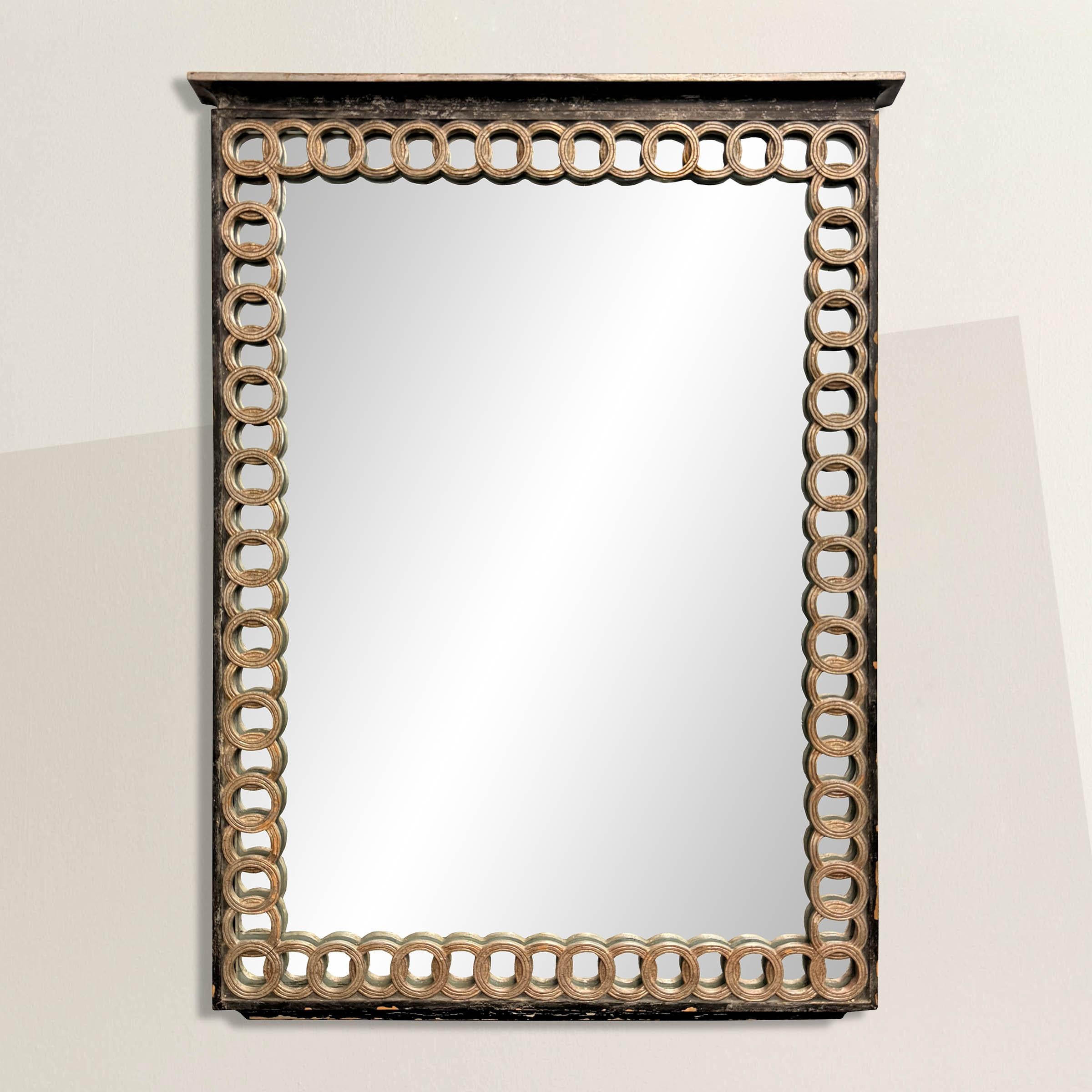 This incredible mid-20th century Italian mirror boasts a subtly architectural frame. Crafted with a nod to classical elegance yet infused with a touch of Italian modernity, its design is a testament to timeless sophistication. The frame features a