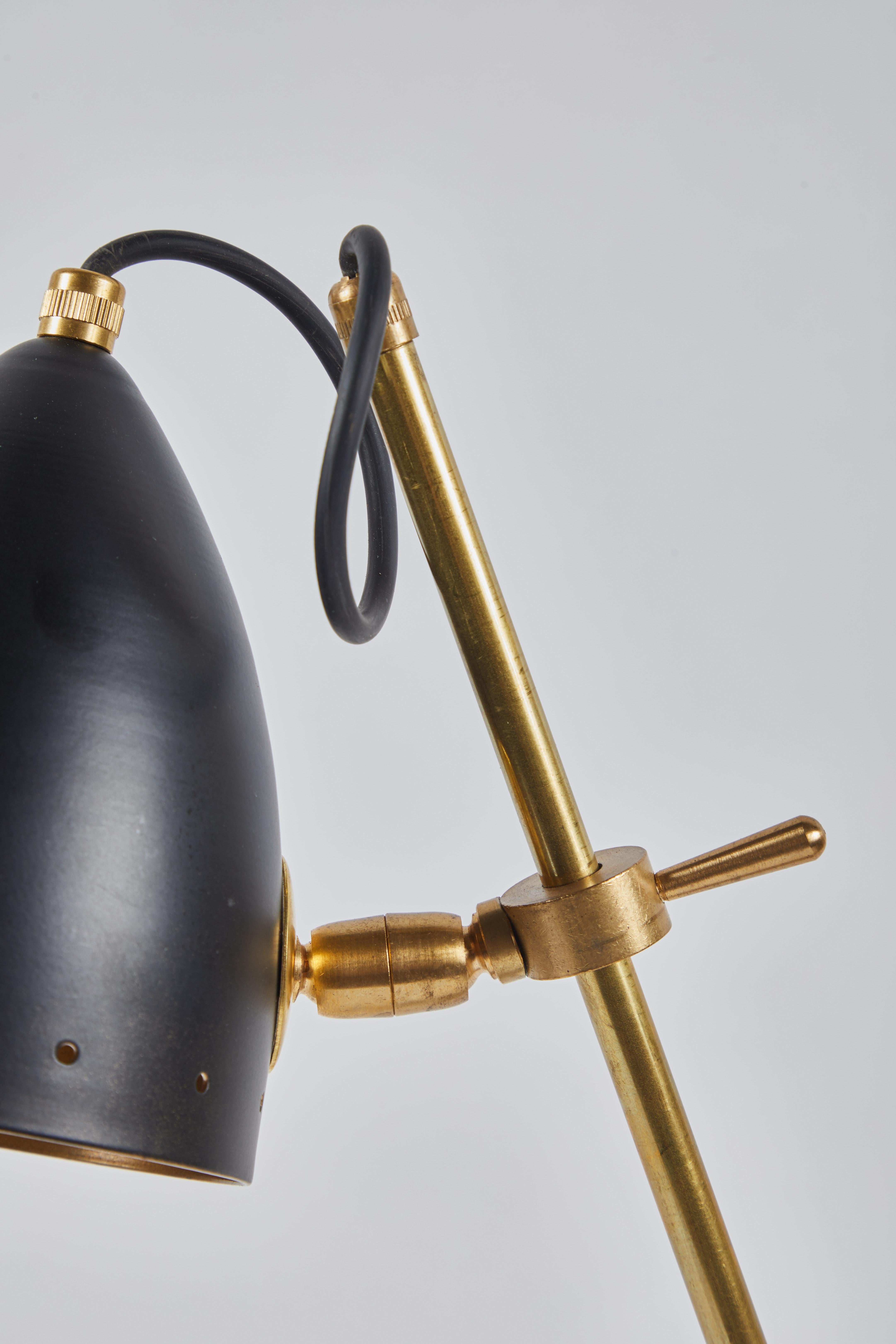 Italian midcentury articulated brass lamp on marble base with matte black shade.