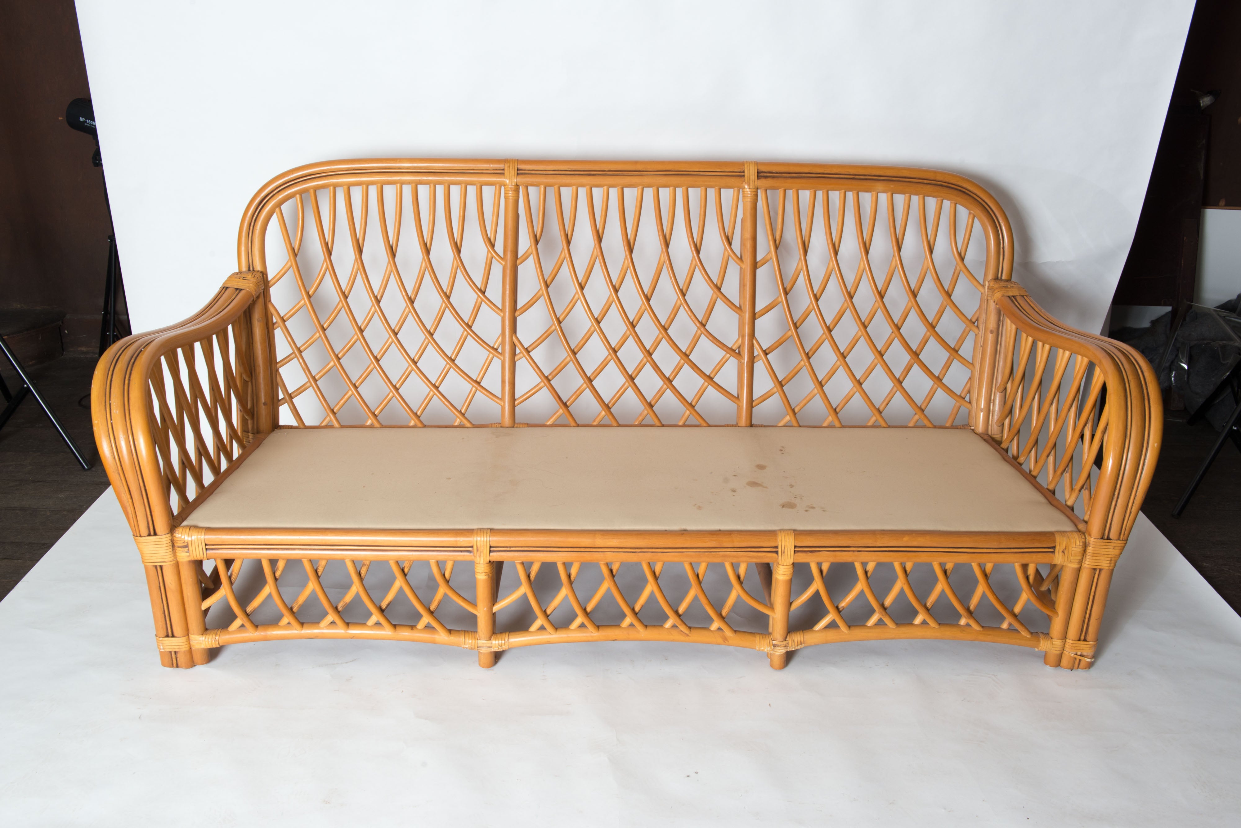 A midcentury, possibly Italian organic modern sofa in handcrafted rattan. Strong and sturdy woven diamond pattern rattan sofa. This sofa is in good to excellent condition. This Classic design compliments any decorating style. There are two other