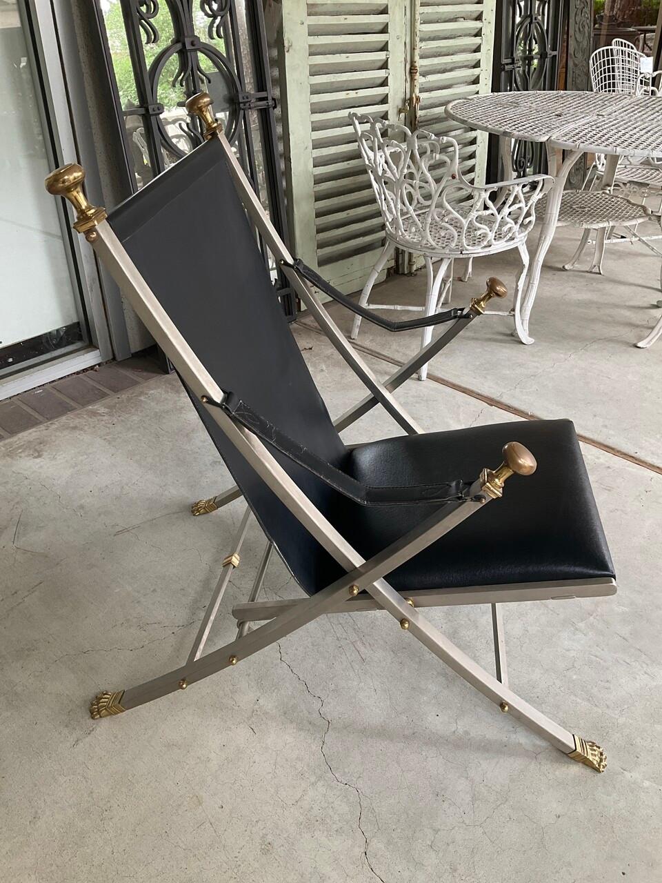 Step into the golden age of design with the Mid-20th Century Maison Jansen Campaign Chair, a true icon of vintage luxury and functionality. Crafted by the esteemed Maison Jansen, renowned for their impeccable taste and attention to detail, this