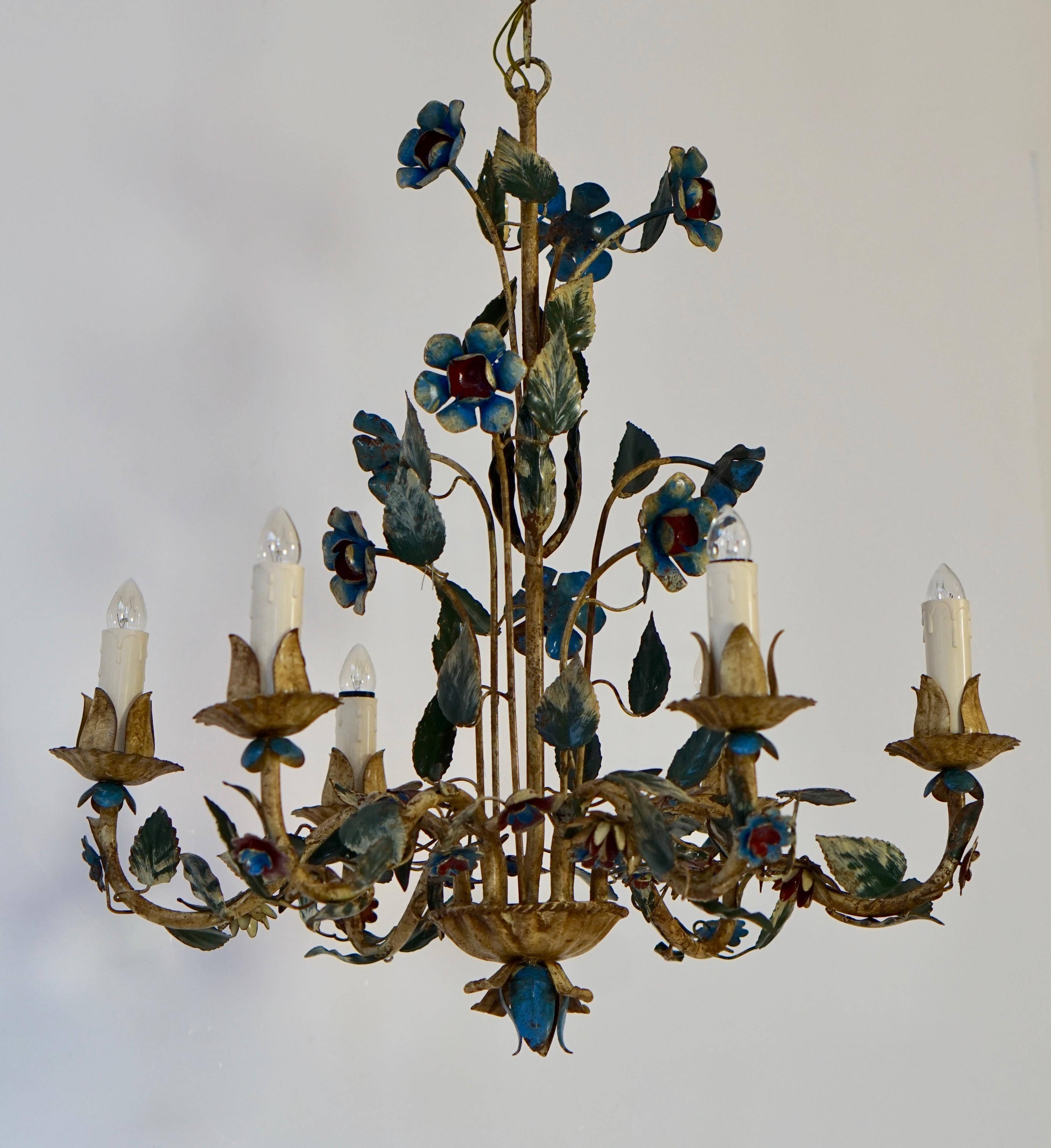 This elegant, vintage chandelier was crafted in Italy, circa 1950. The charming hanging light fixture has six lights and is embellished with realistic flowers and green leaves. The round chandelier is in very good condition and has its original
