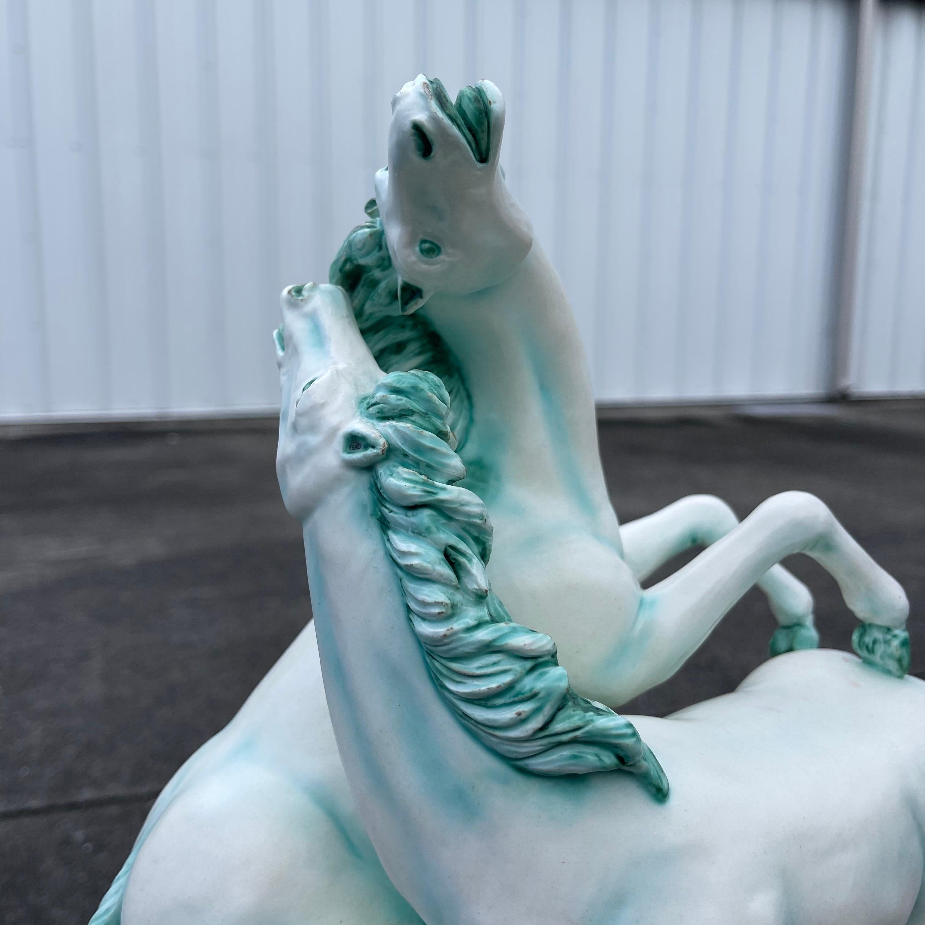 Striking depiction of a pair of prancing wild horses.