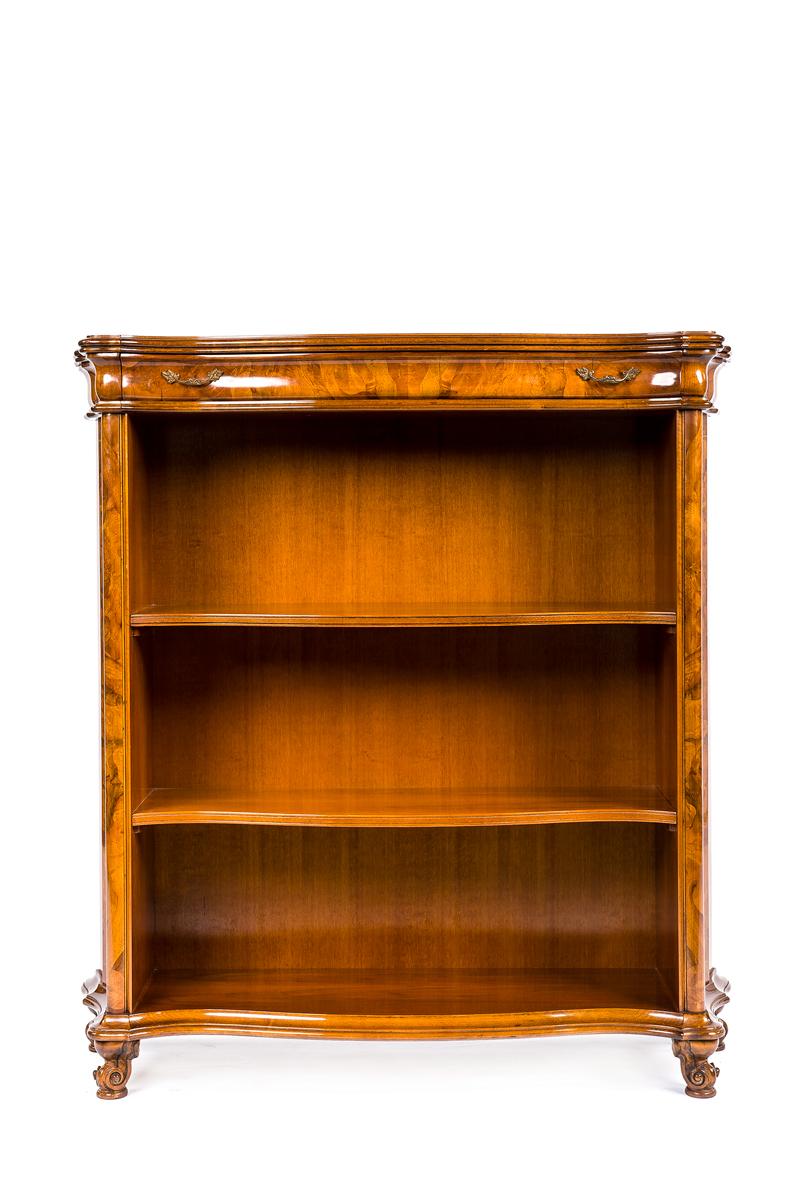 A beautiful 20th century Rococo style bookcase with drawer on top. The whole piece is decorated with intricate inlaid patterns of flowers and leaves. The piece has a serpentine front and stands on 4 elegant carved feet. The two shelves are fixed and