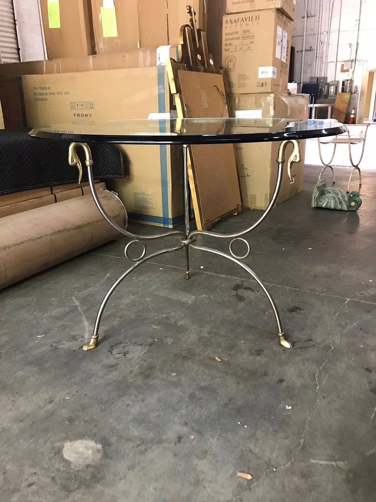 Mid-20th century Italian round steel Gueridon table with brass swans, brass feet, and glass top, circa 1970s
In the style of Maison Jansen
Glass top has beveled edge.