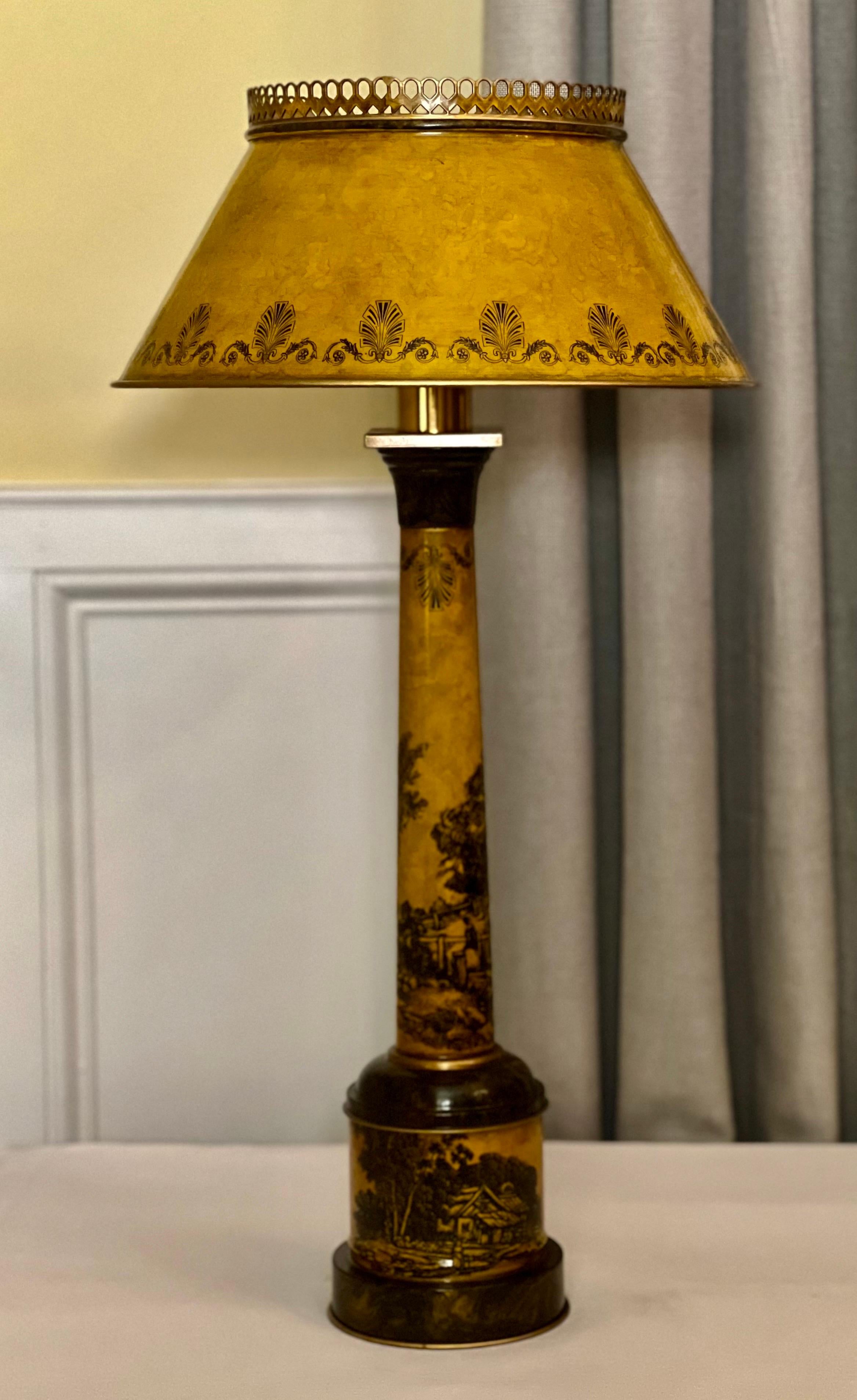 Mid 20th century Italian tole lamp with original shade.

Fine Italian tole column form table lamp in a warm ochre hue. It is intricately painted with a tranquil pastoral scene with animals, figures, a farmhouse, fence and elements of nature. The