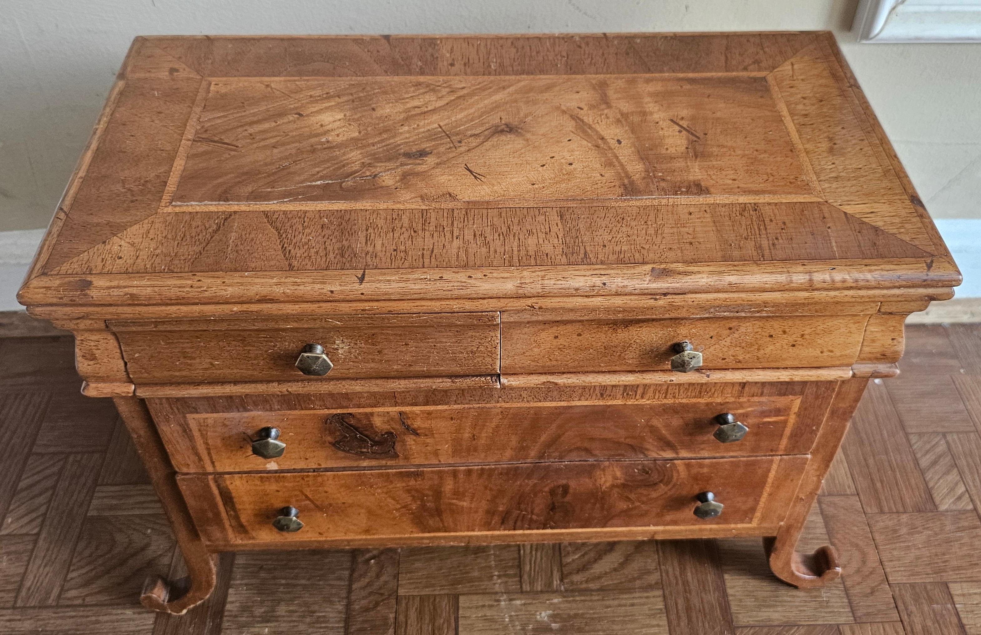 A Mid 20th Century Italian Walnut Crossbanded and Inlaid Jewelry Box with scroll legs. Measures 16.5