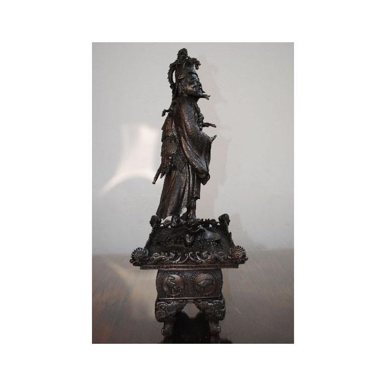Zhong Kui legendary figure demon hunter from China widely represented in Japanese art perched on a dragon scenery with Chinese astrological signs on the base. Work of the second half of the 20th century. Black patina.