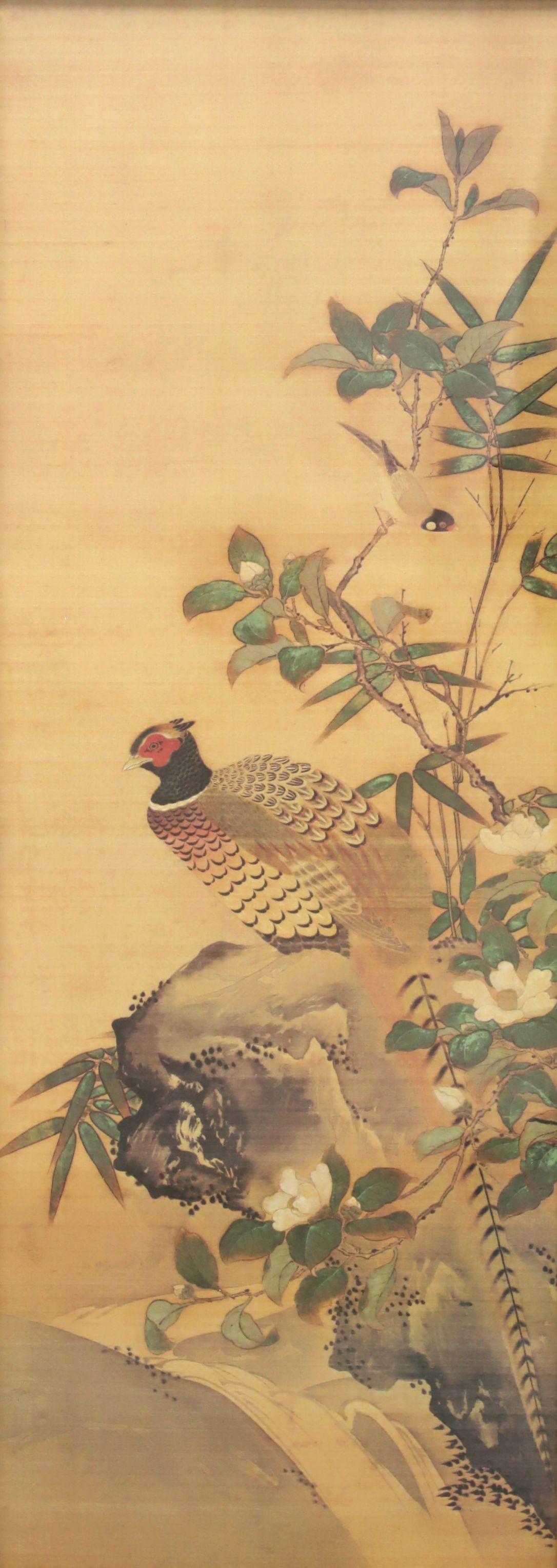 A pair of framed Japanese prints on paper depicting birds in nature, from the mid 20th Century. Each is presented framed behind glass in a faux bamboo and wood frame. Faux bamboo has been painted gold with surrounding wood frame painted a bronze