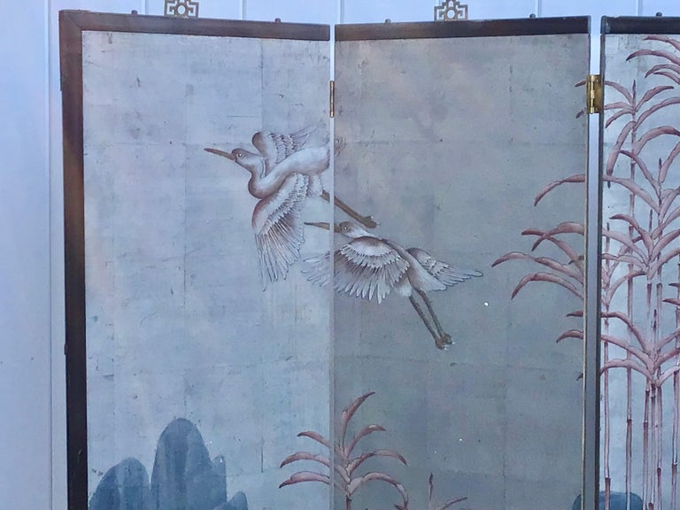 Vintage Japanese four panel wallpaper screen featuring a beautiful hand-painted blue paper ground with pastel scene of delicate bamboo, mountains and birds. Set in an ebonized wooden frame.
