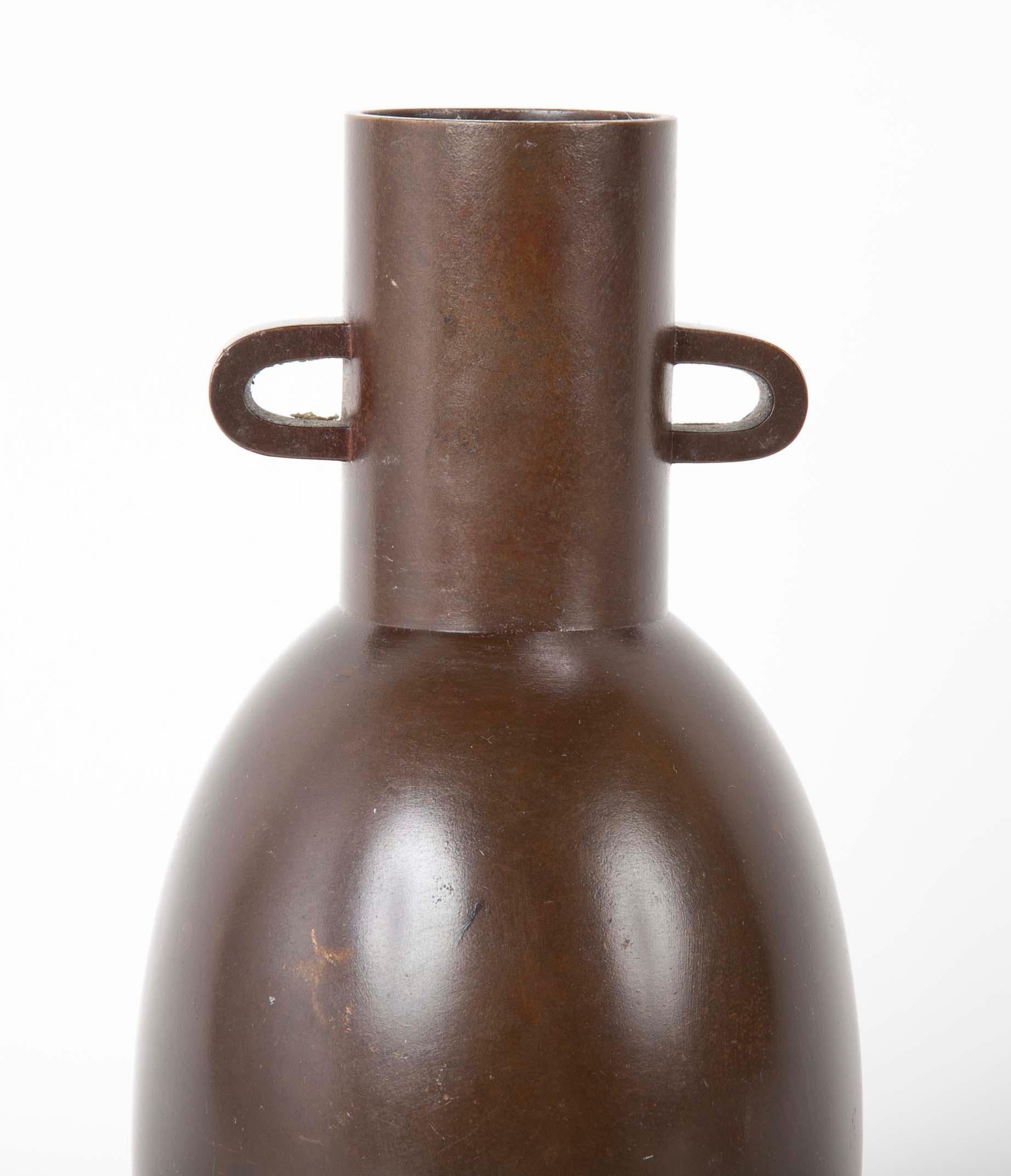 A Showa period (1926-1989), Japanese ovoid shaped bronze vase with cylindrical neck and loop handles. Signed with box.