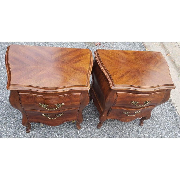 Pair of John Widdicomb Bombe style walnut nighstands in excellent condition. 
This gorgeous set of 2 Night Tables/Small Dressers made out of wood, solid wood, and Veneer, and it has a light/medium Walnut stain finish color . This beautiful Night