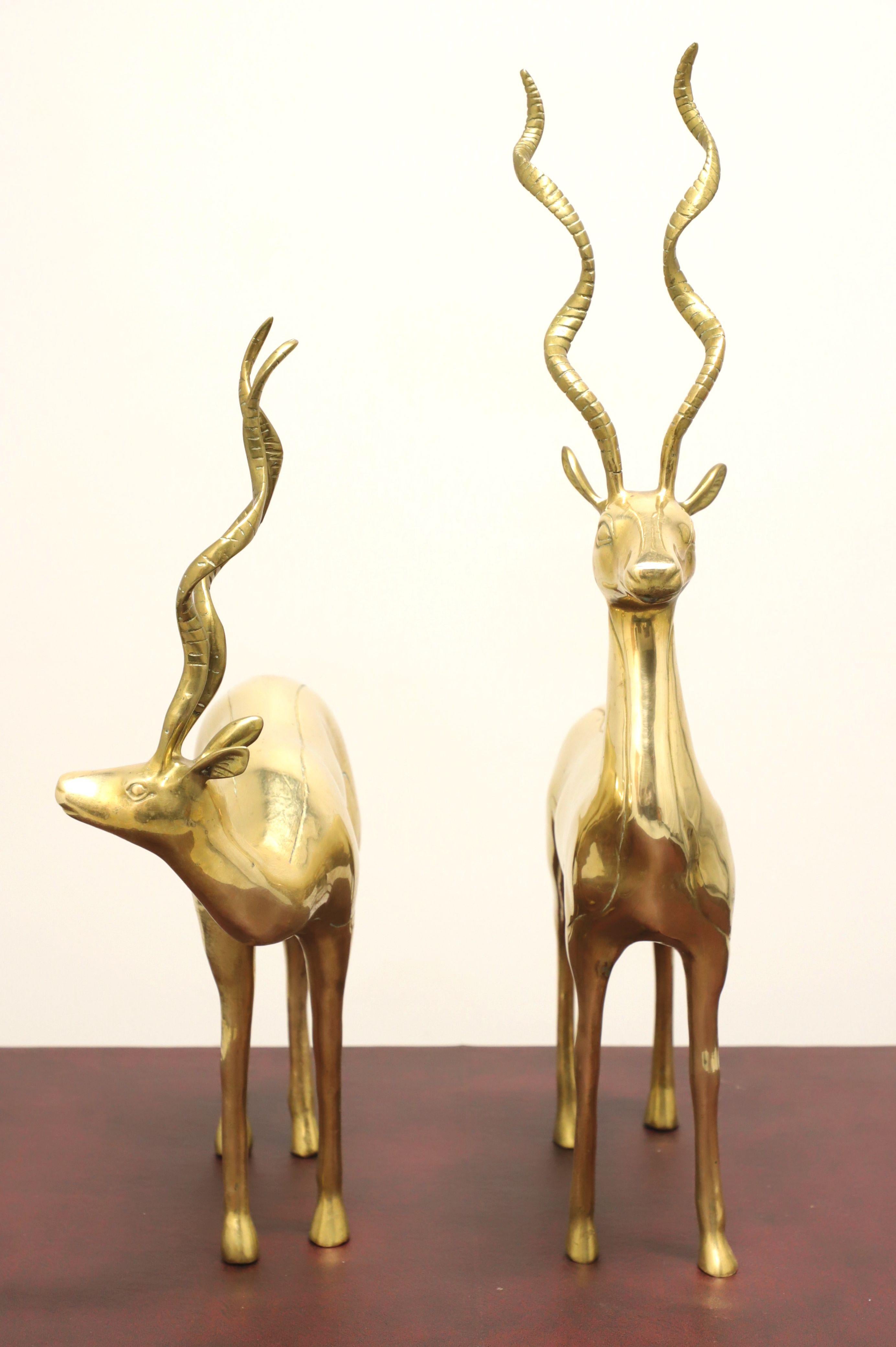 A pair of Mid 20th century brass sculptures, unbranded. Solid casted brass depicting standing antelopes. Likely made in the USA.

Measures: Left: 5.5w 14d 22h, Weighs: 10lbs; Right: 4w 14d 27.25h, Weighs: 10lbs

Exceptionally good condition with