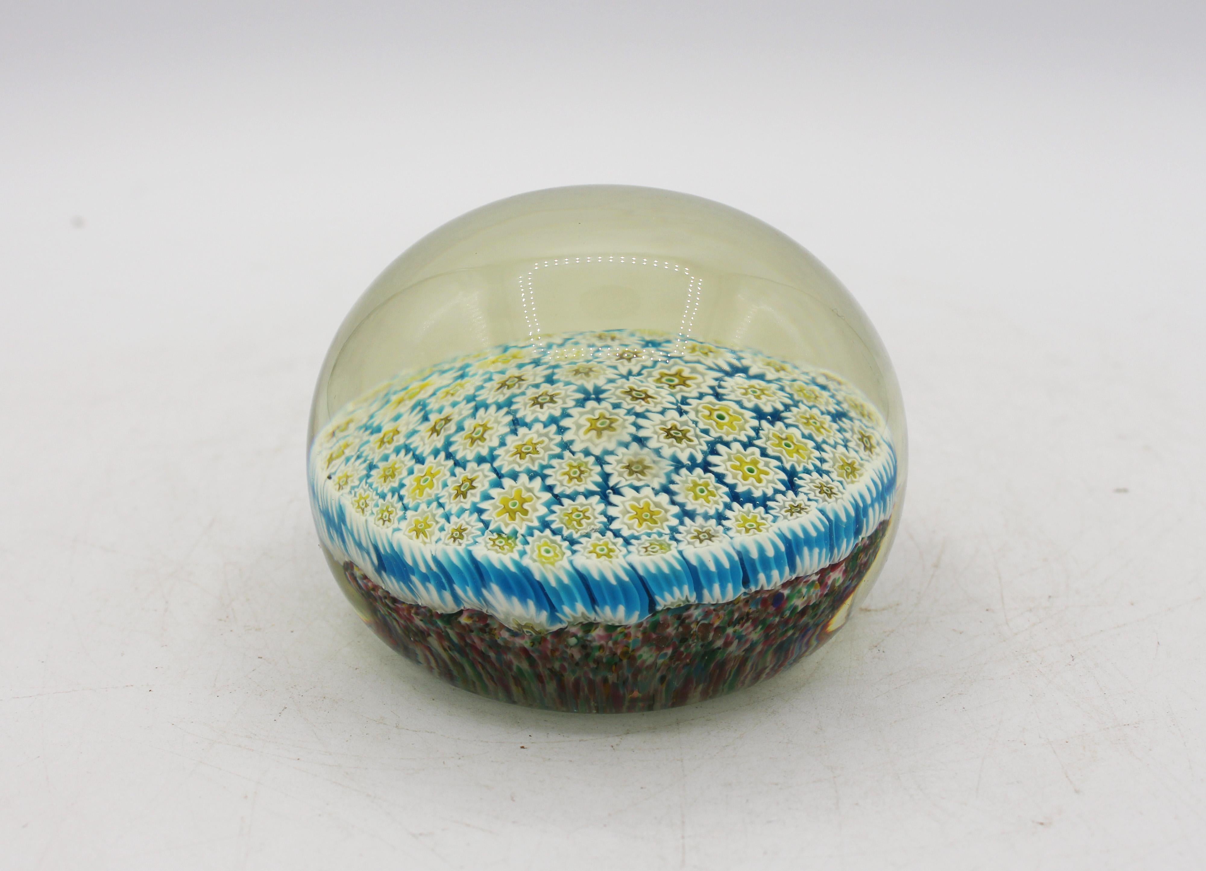 Mid-20th century large Murano glass millefiori paperweight. Yellows & blues with white predominant. Look underneath to see the amazing structure.
3 5/8