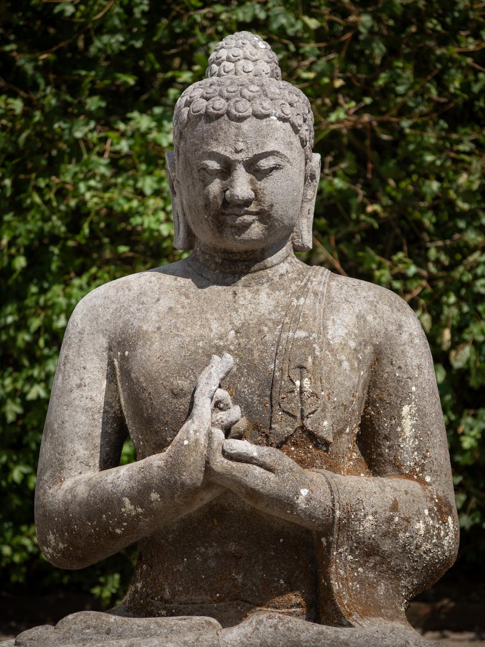 The large old lavastone Buddha statue is a captivating embodiment of spiritual artistry, skillfully carved from the enduring lavastone material. Standing at an impressive height of 125 cm, with dimensions of 98 cm in width and 70 cm in depth, its
