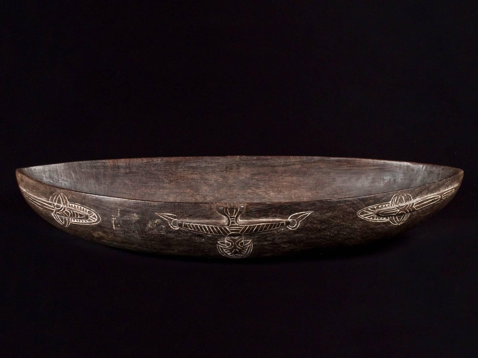 Mid-20th century large tribal wood food bowl, Tami Island, Huon Gulf, Papua New Guinea.

Tami Islanders created intricately carved hardwood bowls, which formed an essential component of the bride-wealth gifts exchanged at marriage ceremonies.