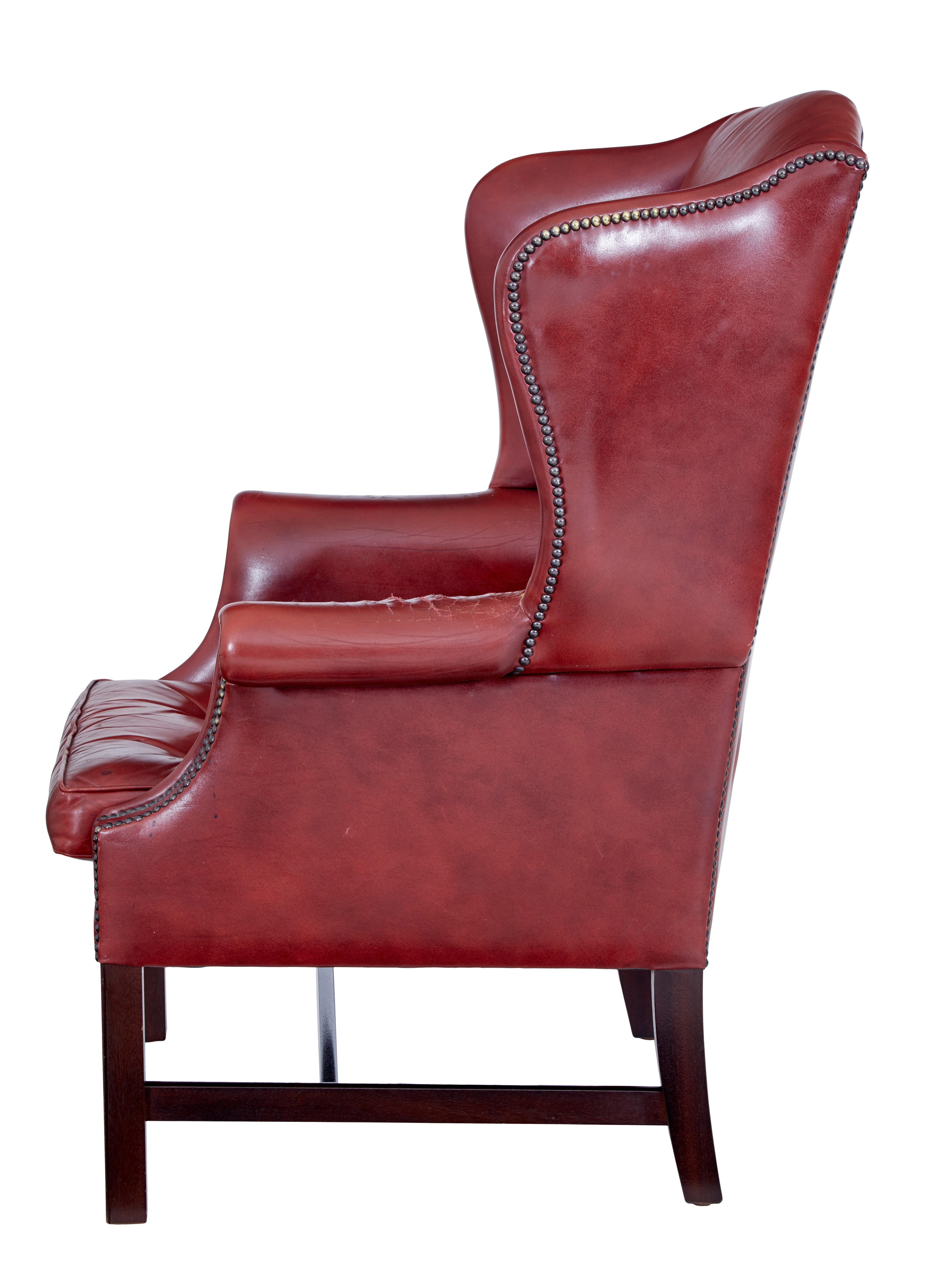 Hand-Crafted Mid 20th century leather wingback armchair For Sale