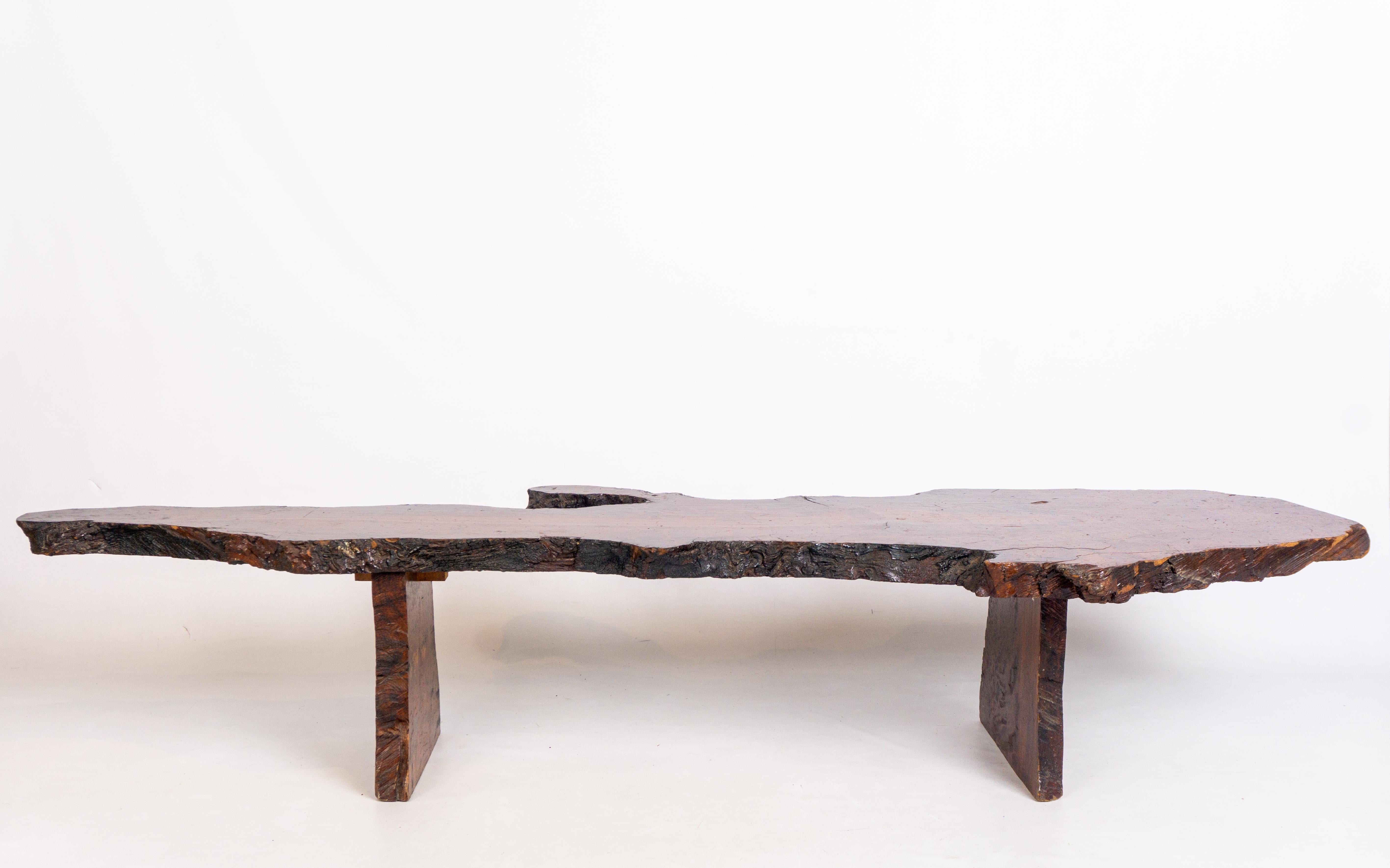 Introducing the Mid-20th Century Live Edge Redwood Bench/Coffee Table, a remarkable piece of furniture that seamlessly blends functionality with artistic flair. Crafted with utmost care and attention to detail, this extraordinary creation exudes
