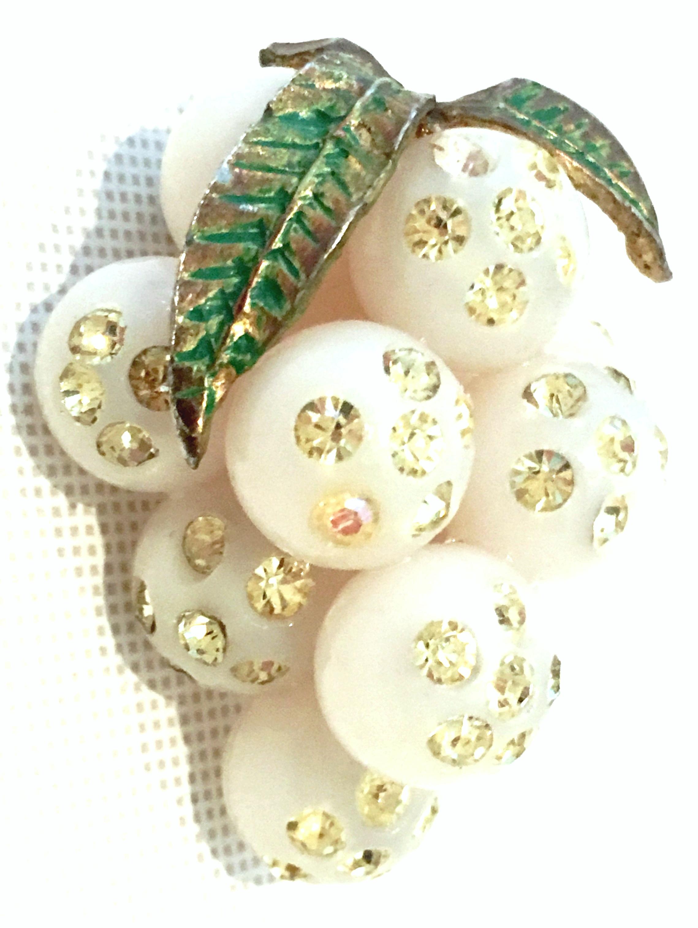Mid-20th Century Art Nouveau Gold, Lucite & Austrian Crystal Dimensional Grape Bunch Brooch.
This rare and pristine sculptural Lucite grape bunch brooch features antique white Lucite grapes with brilliant canary yellow Austrian crystal stones and