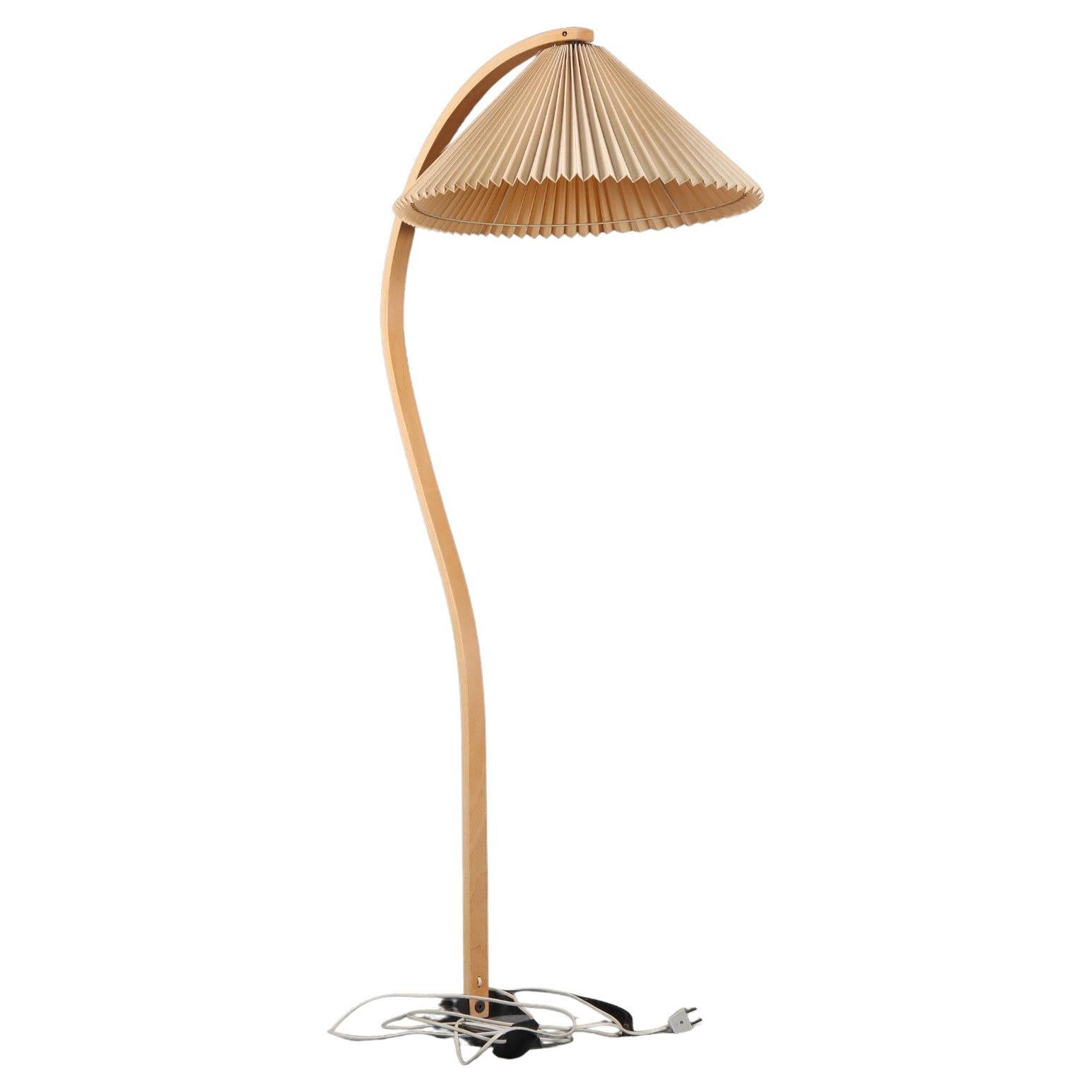 Elegant Mads Caprani Danish floor lamp, circa 1970's. Iconic bentwood beech stand is complemented by beige pleated shade.