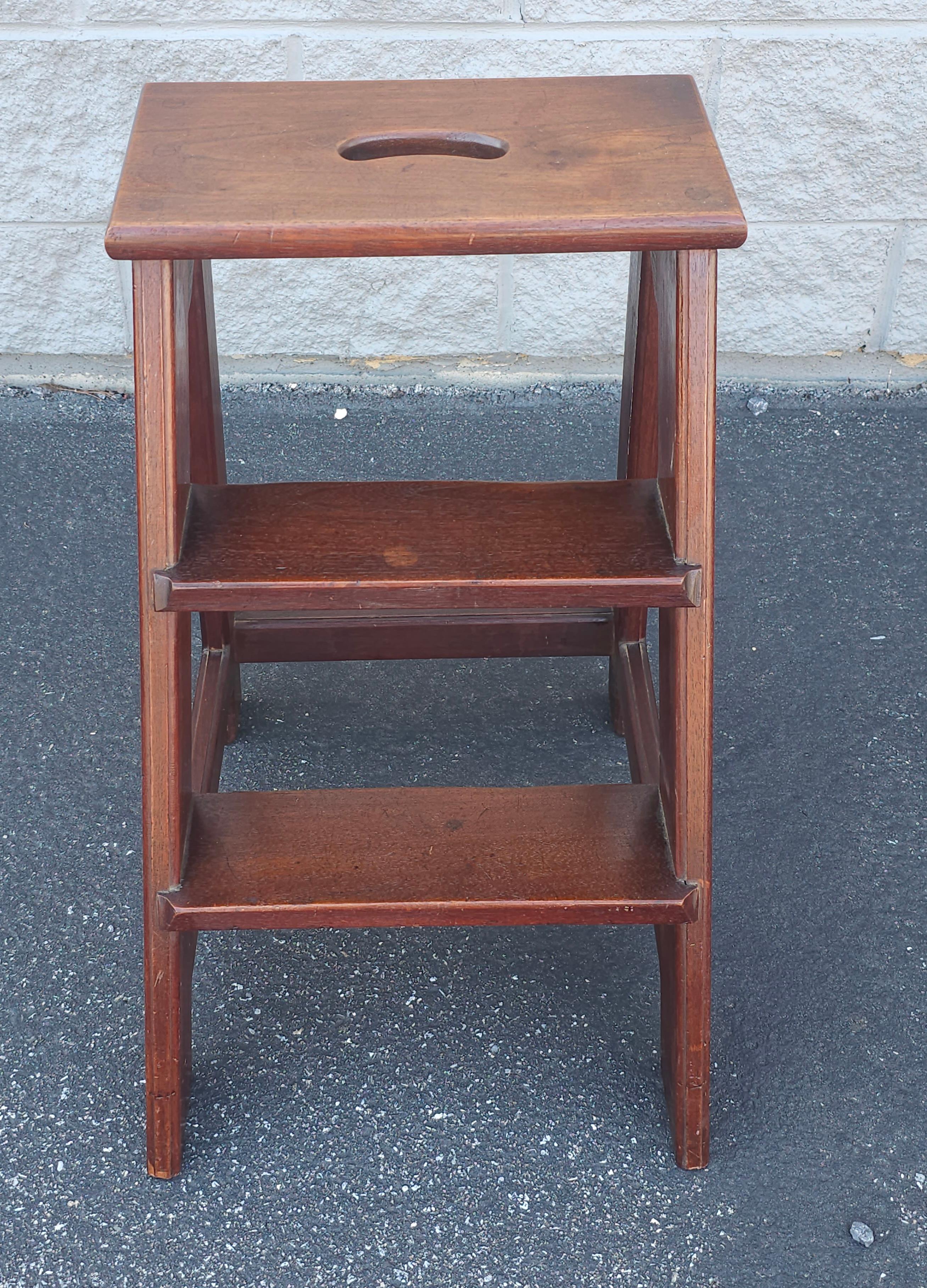 An early to Mid 20th Century Magogany rock solid Library Step Ladder with top handle. Measures 14.5