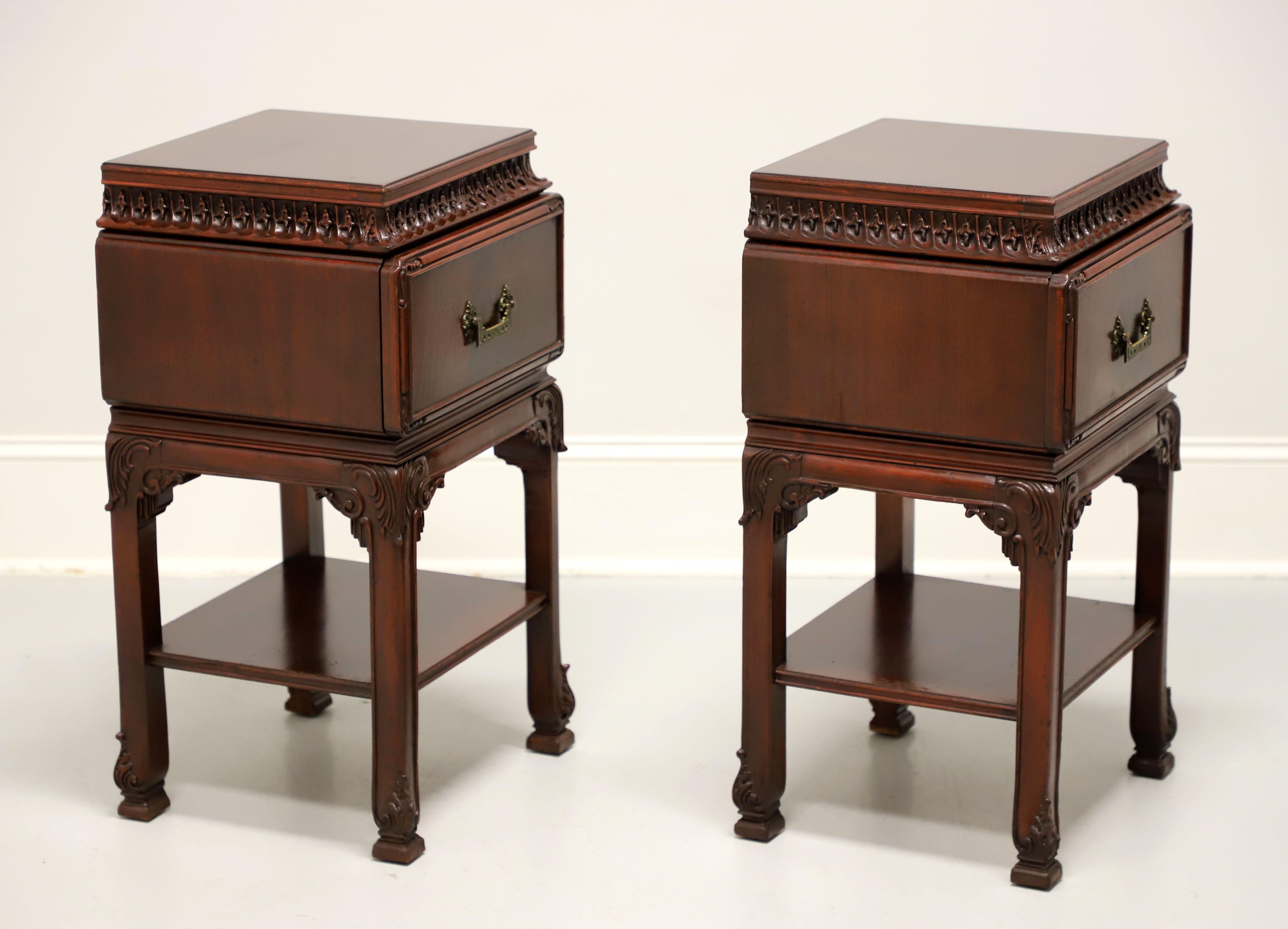 A pair of Asian influenced nightstands, unbranded, similar quality to Kindel or Rway. Mahogany with flame mahogany drawer fronts & top, bevel edge to top, decorative brass hardware, distinctive Asian styling, intricately carved under the top, carved
